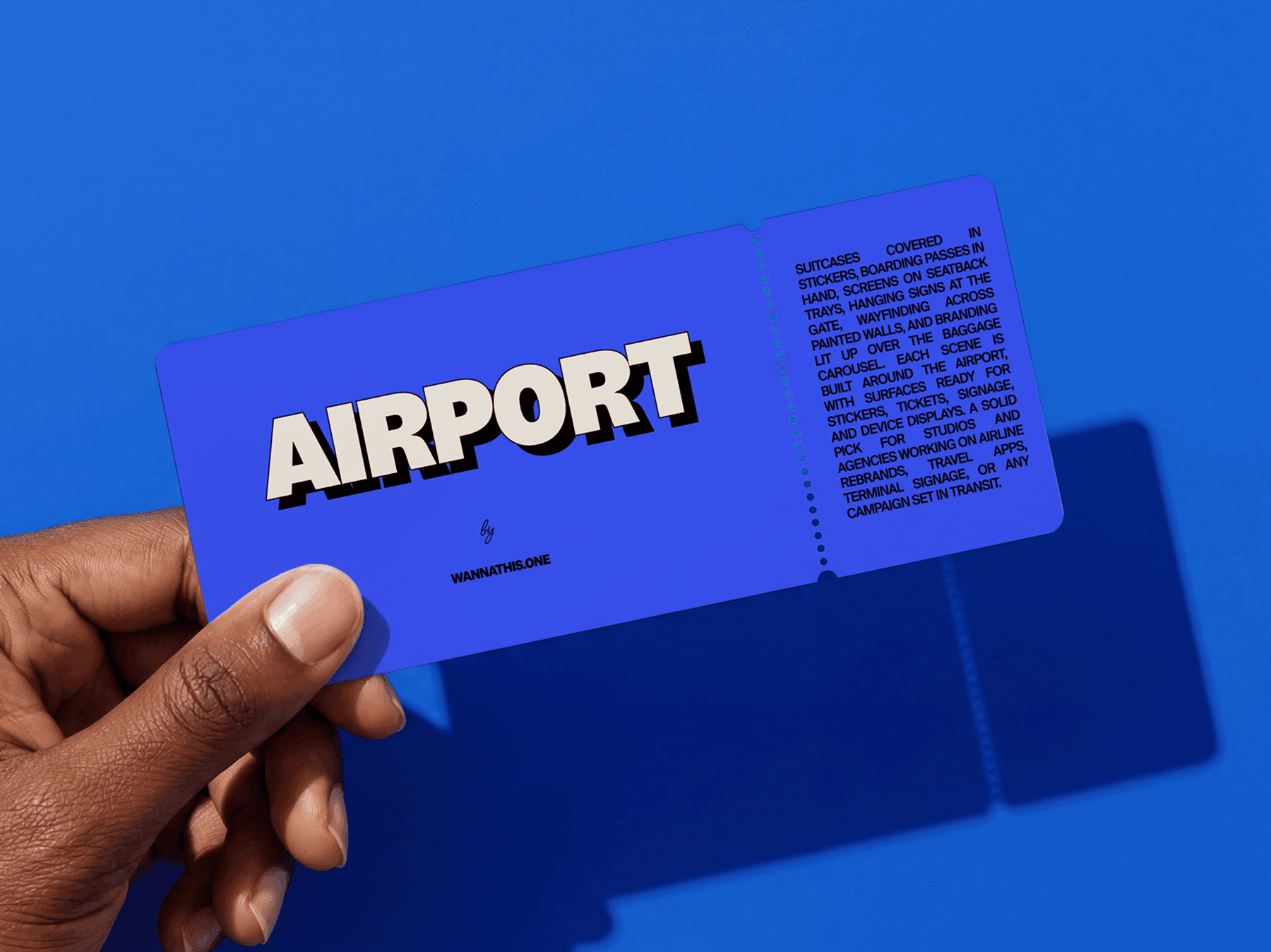 Hand holding an airport ticket style boarding pass card in a refined clean travel studio setup scene