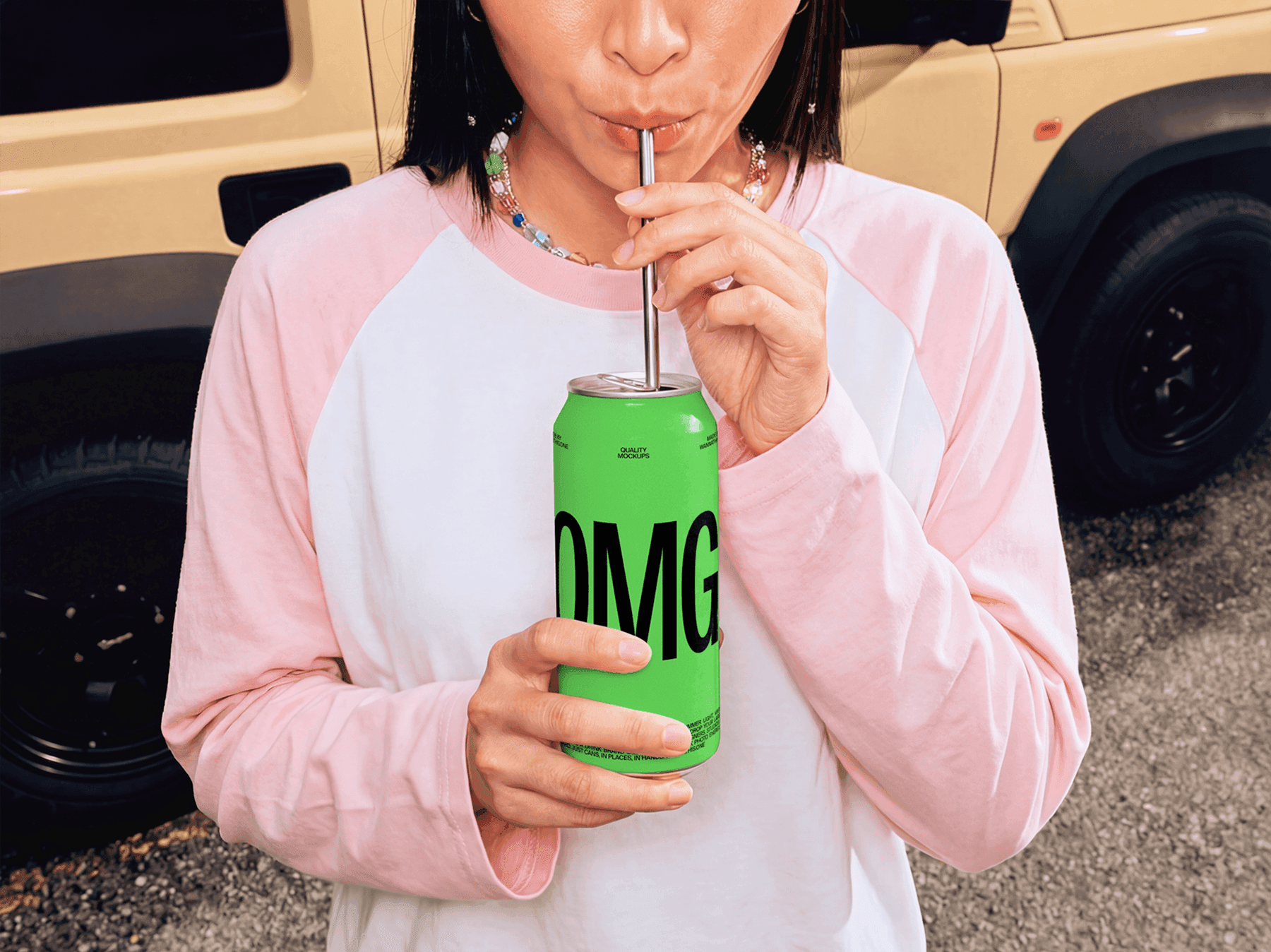 Person drinking from a beverage can mockup with a reusable straw