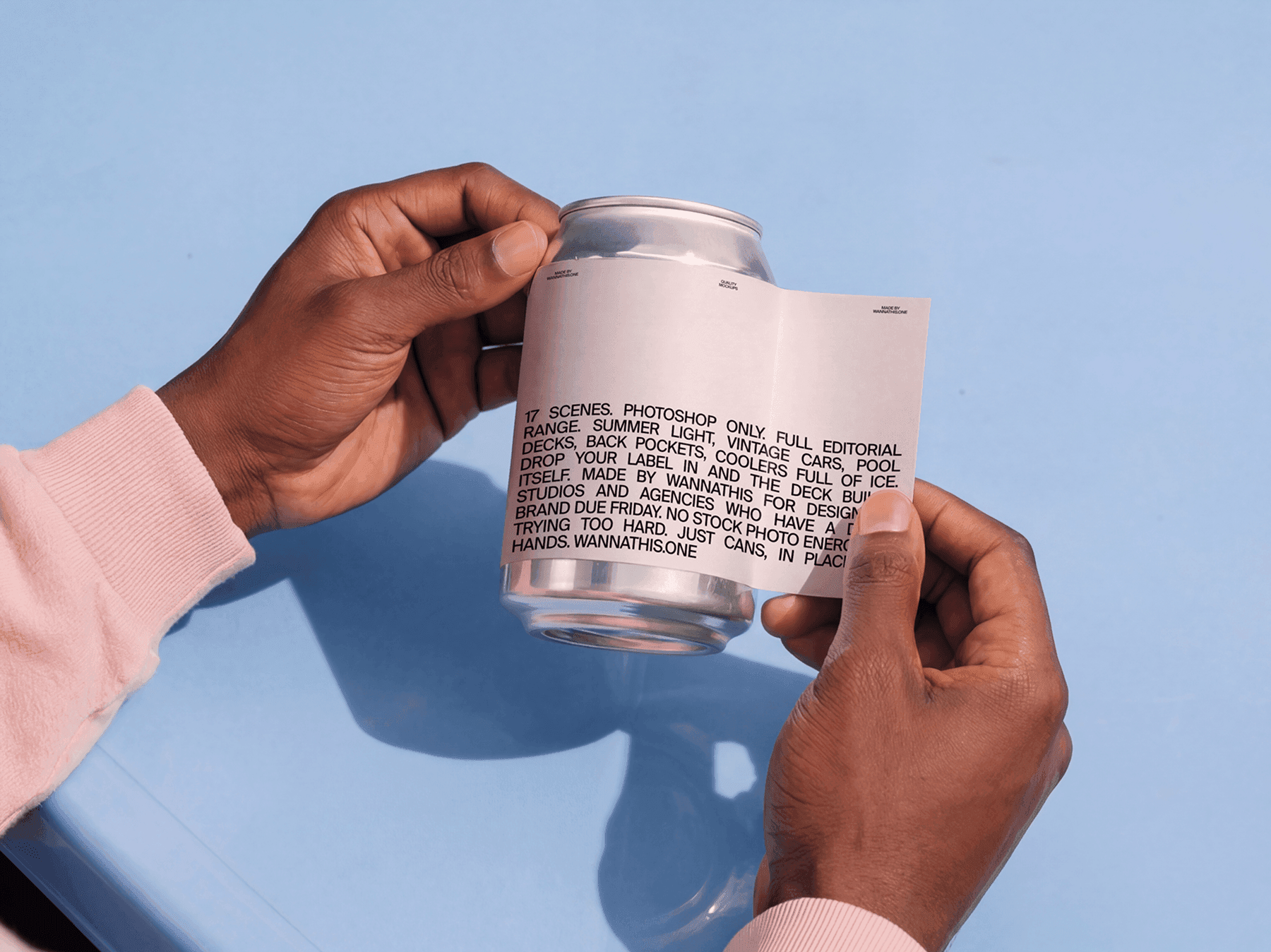 Hands holding a beverage can mockup together with a printed label