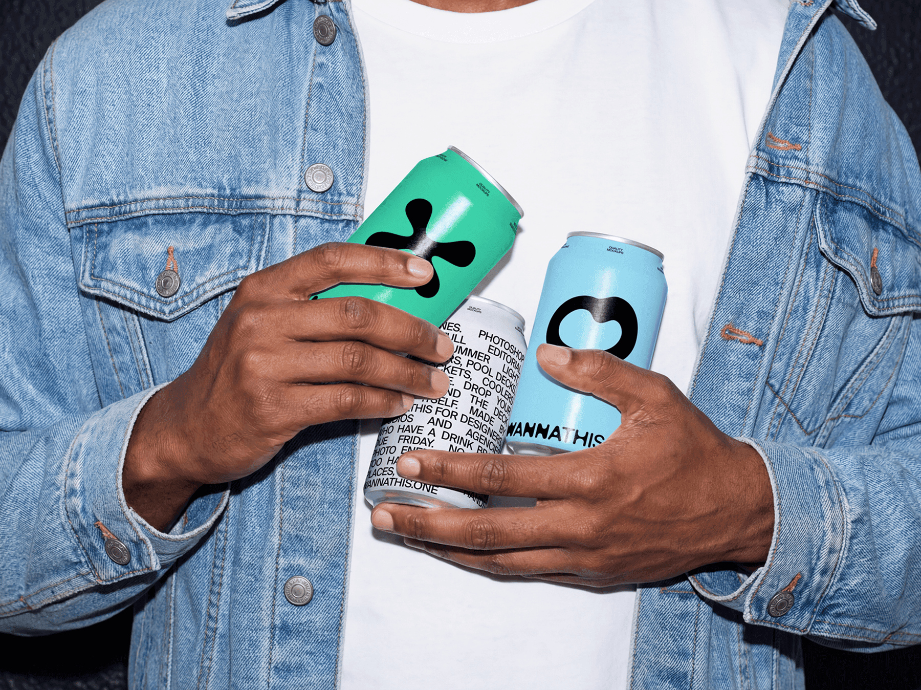 Person holding multiple beverage can mockups in casual outfit