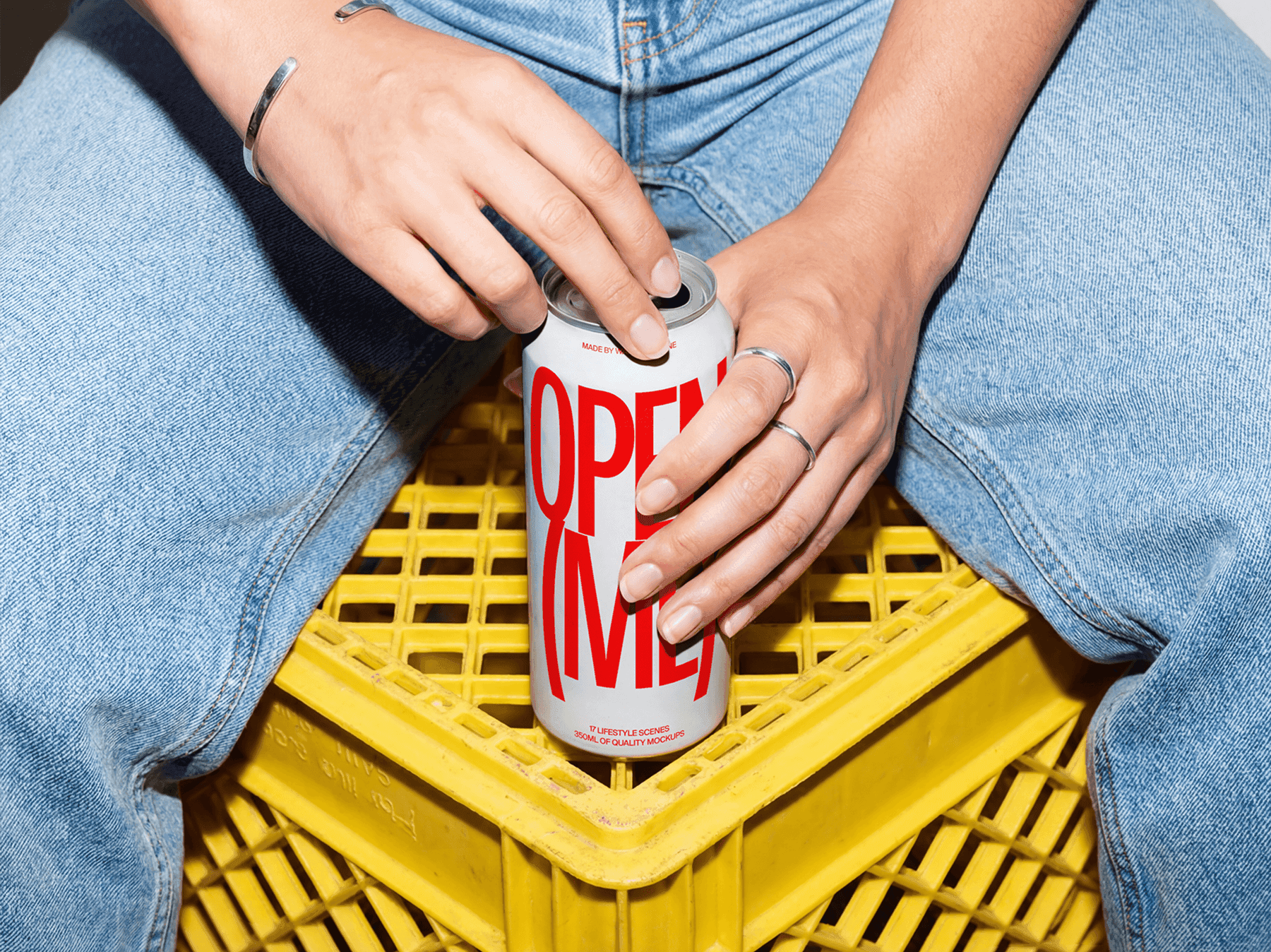 Tall aluminum can mockup held by hands while sitting outdoors