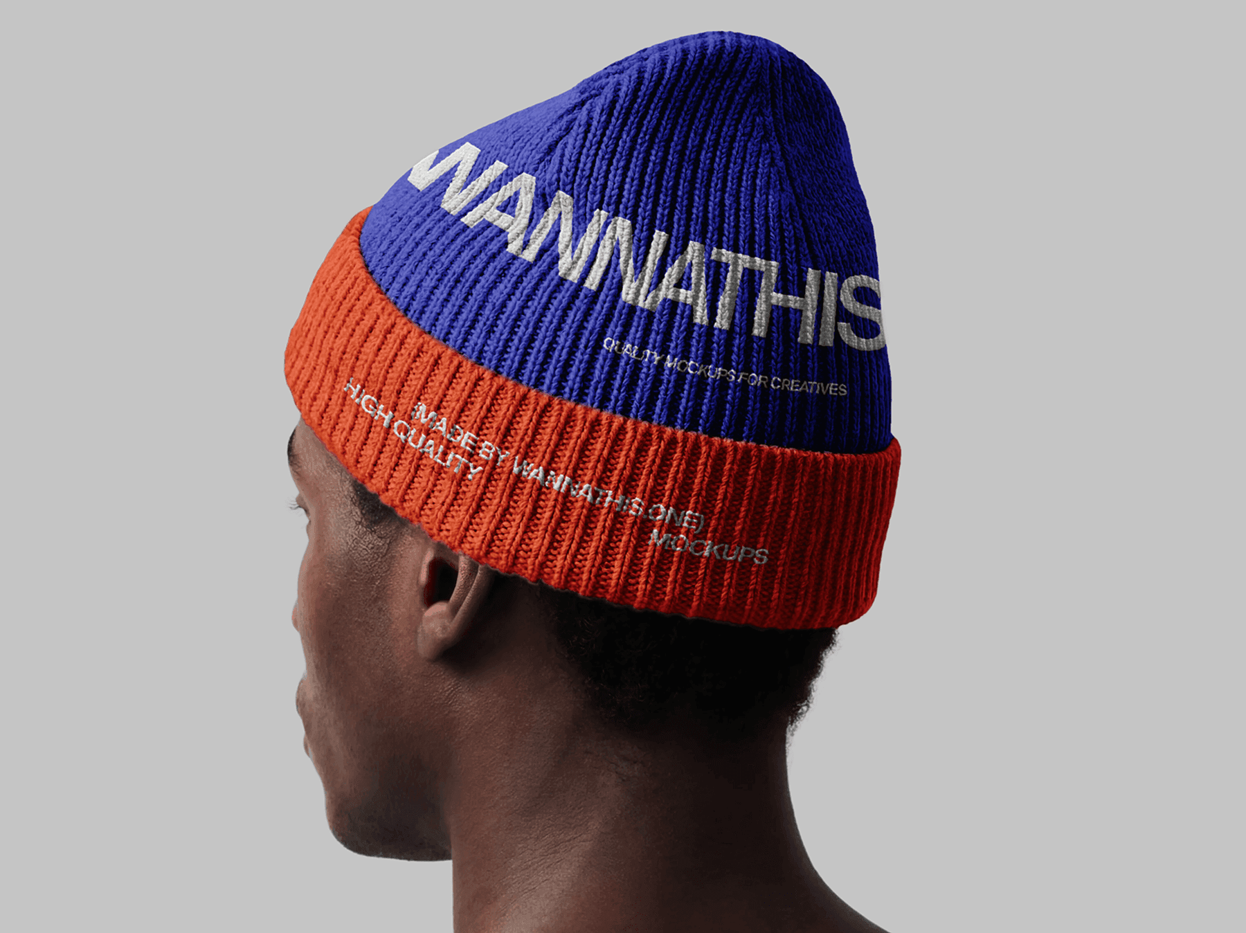 ide view of a model wearing a beanie hat in a studio setting