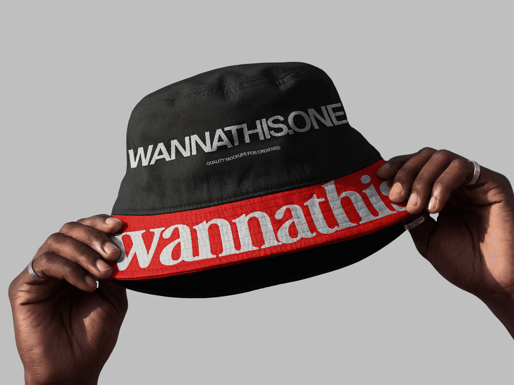 Hands holding a bucket hat in a clean studio environment