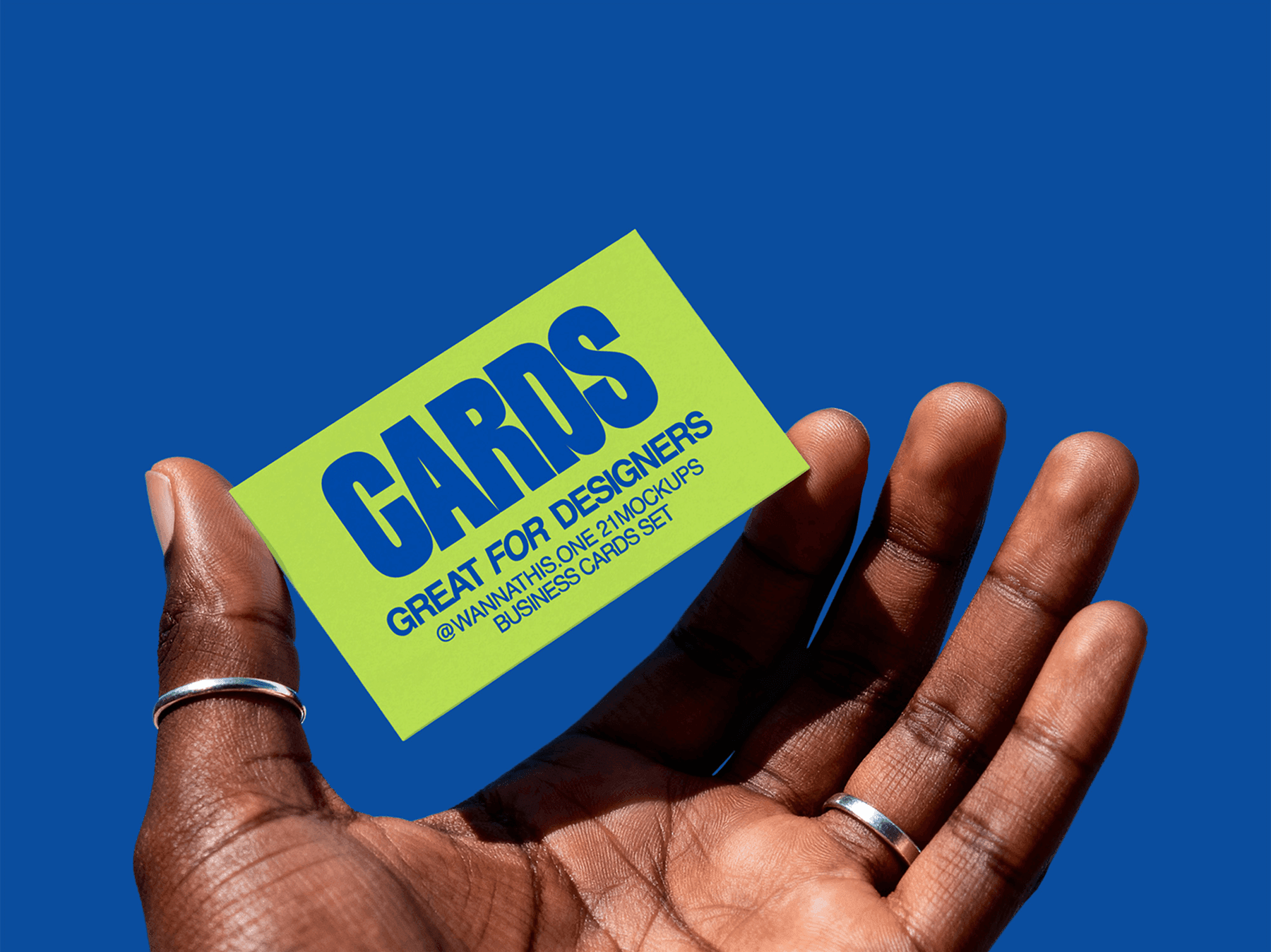 Person holding a business card mockup against blue background