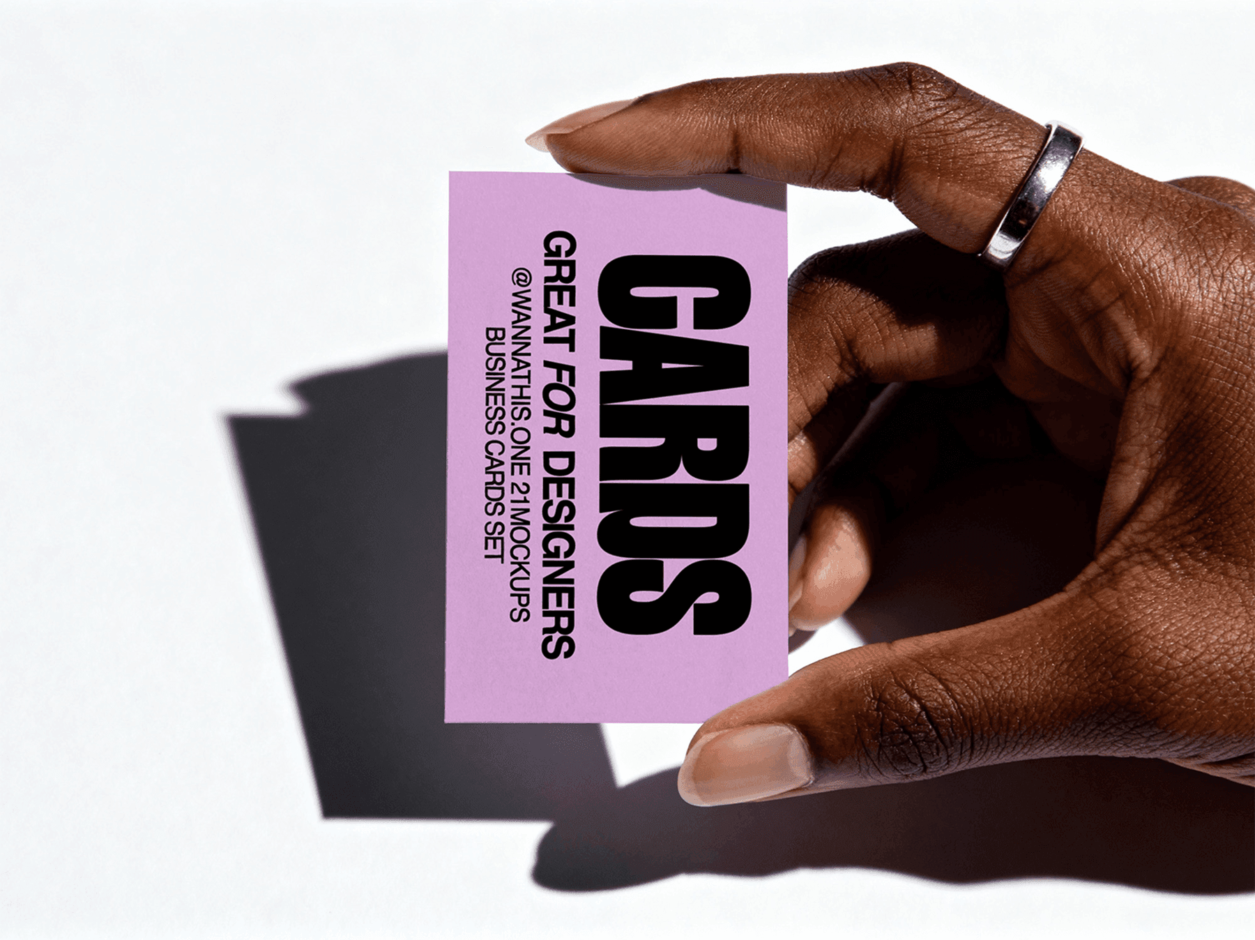 Hand holding a vertical business card mockup under natural light