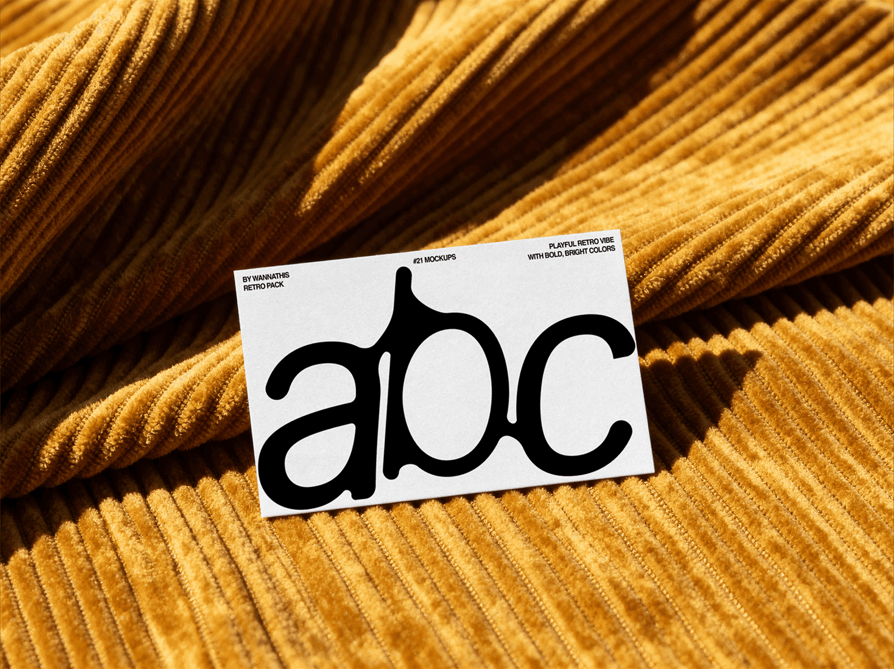 Business card mockup placed on a corduroy surface