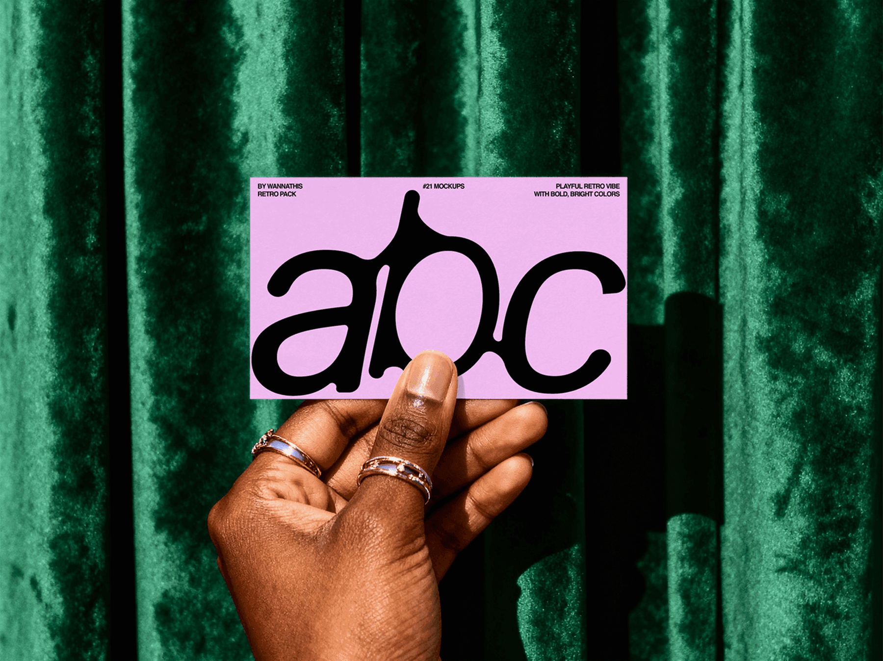 Hand holding a business card mockup in front of a green curtain
