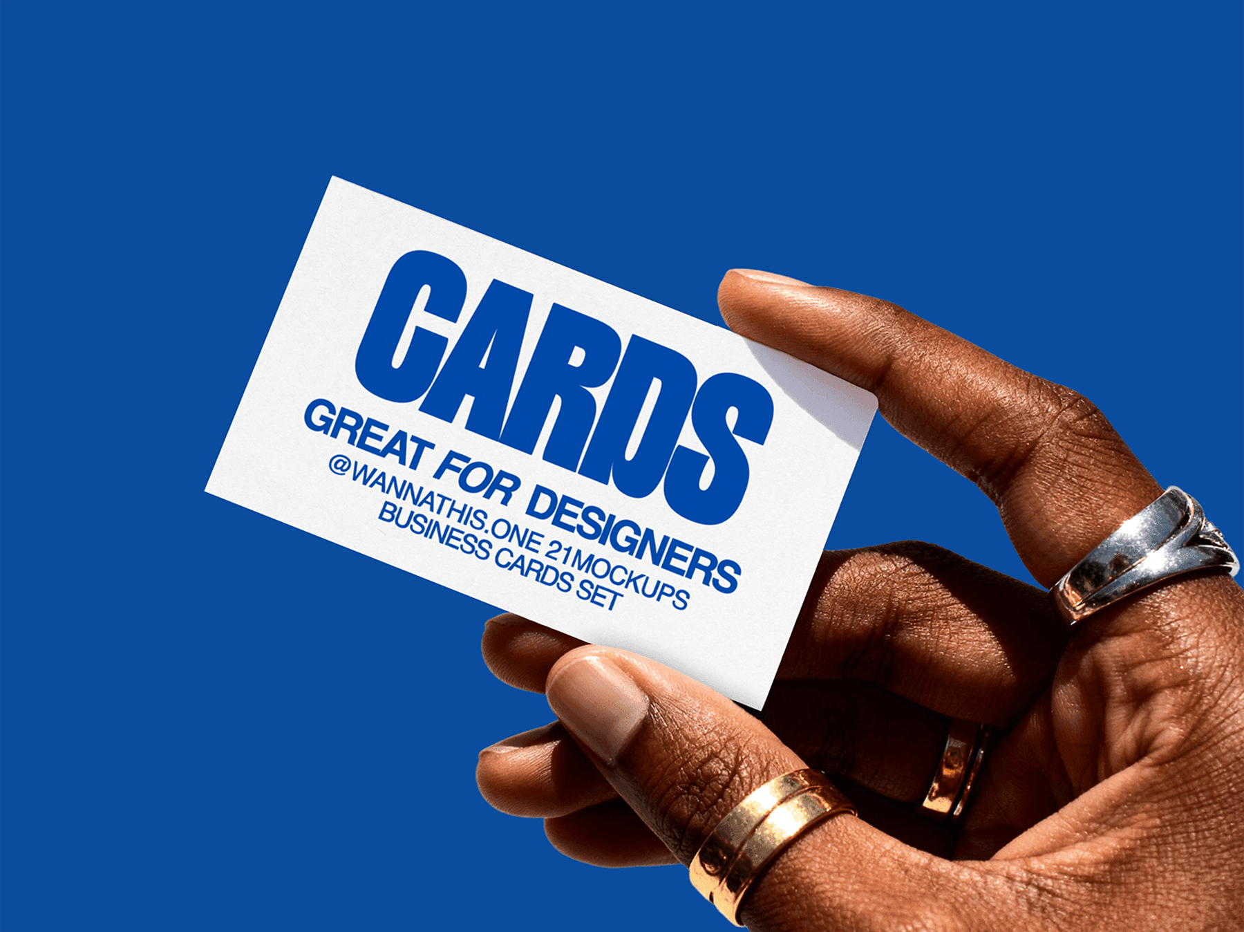 Person holding a business card mockup against a blue background