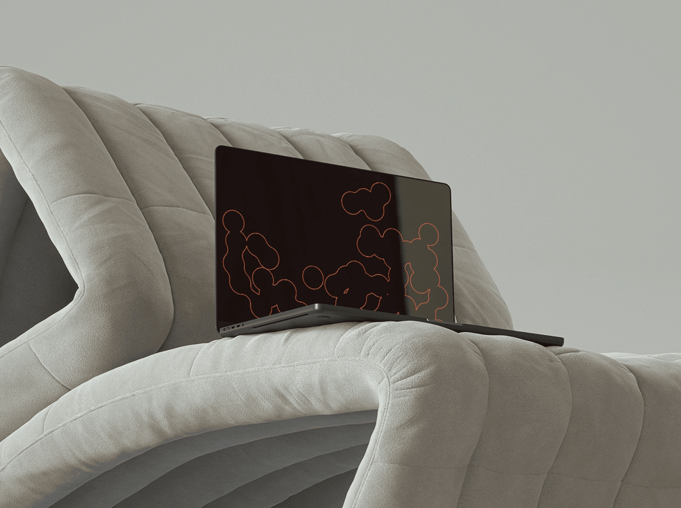 MacBook mockup on soft cloud-shaped chair — cozy neutral interior scene.