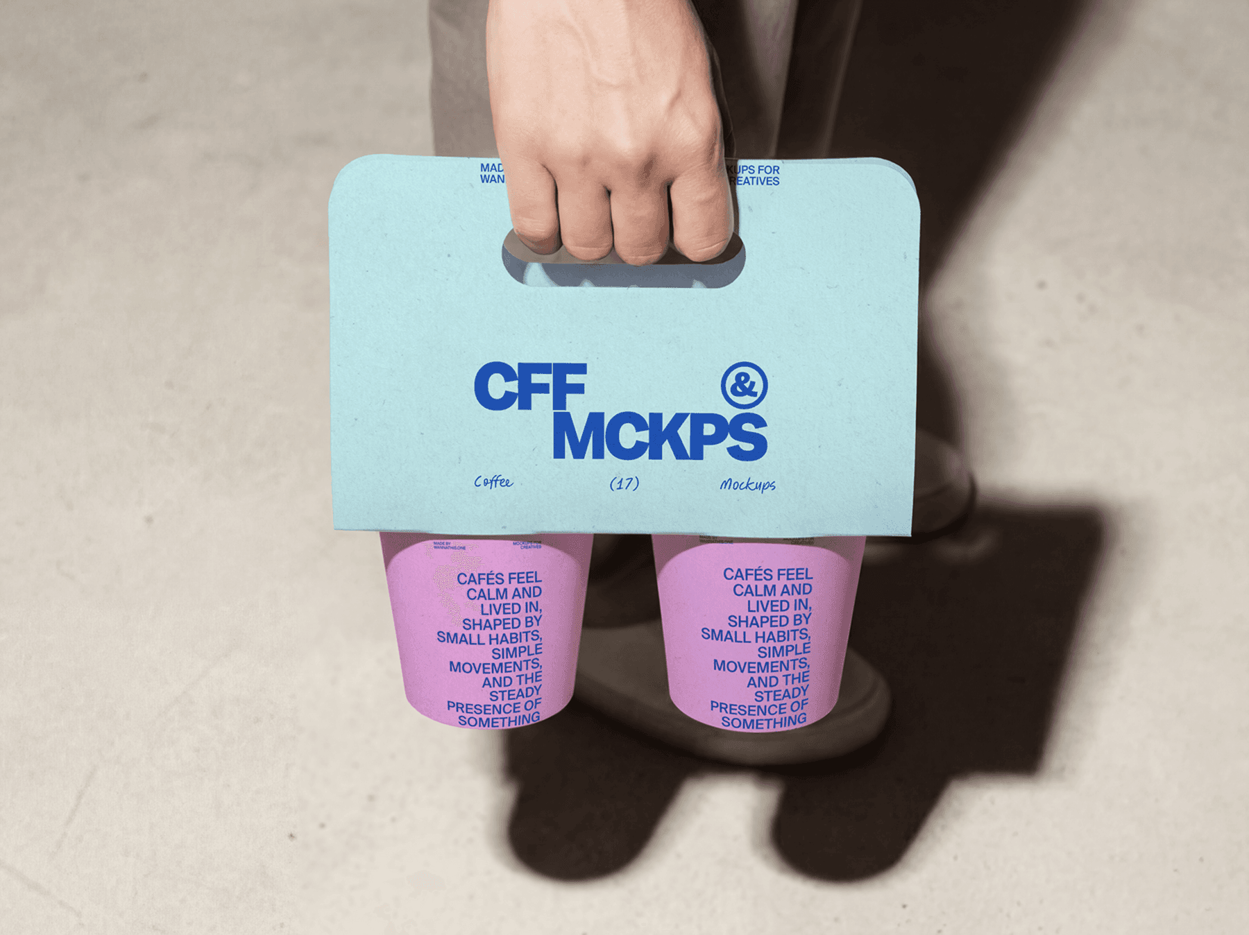 Person holding a coffee cup carrier with takeaway cups inside