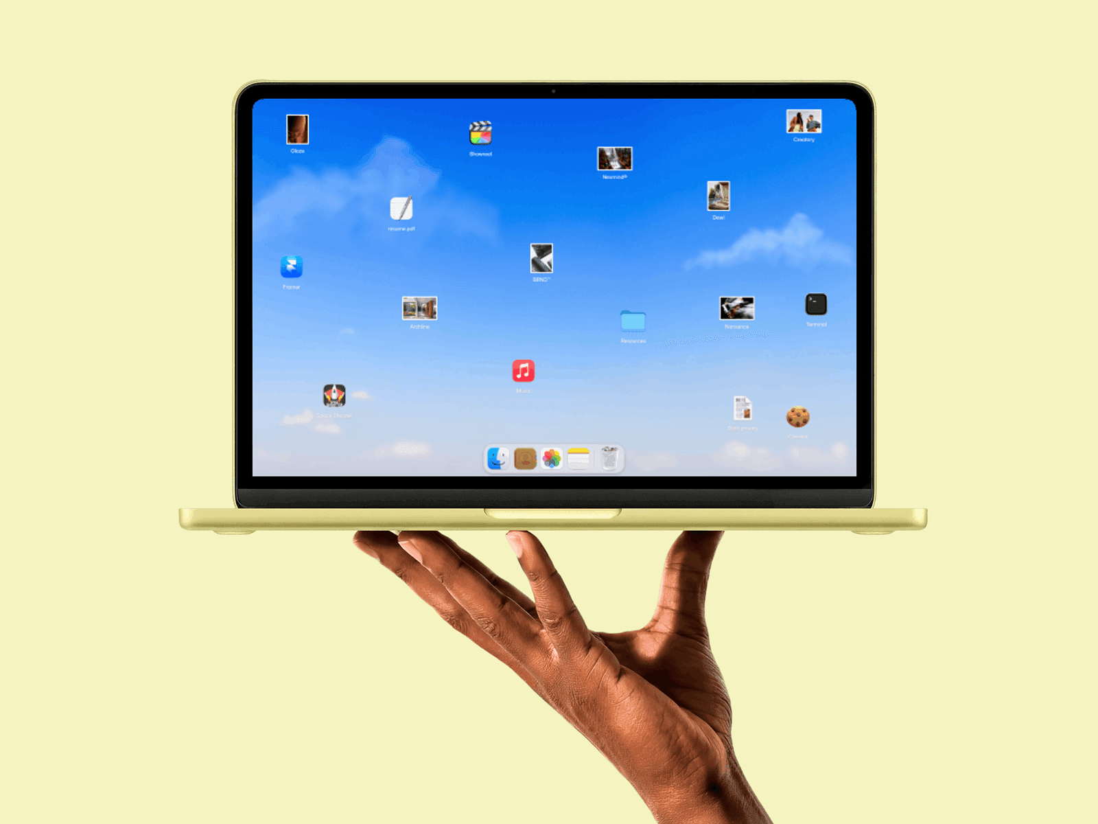 Yellow MacBook held in one hand with a desktop-style portfolio on screen, cover image for an article on the best Framer portfolio templates for designers