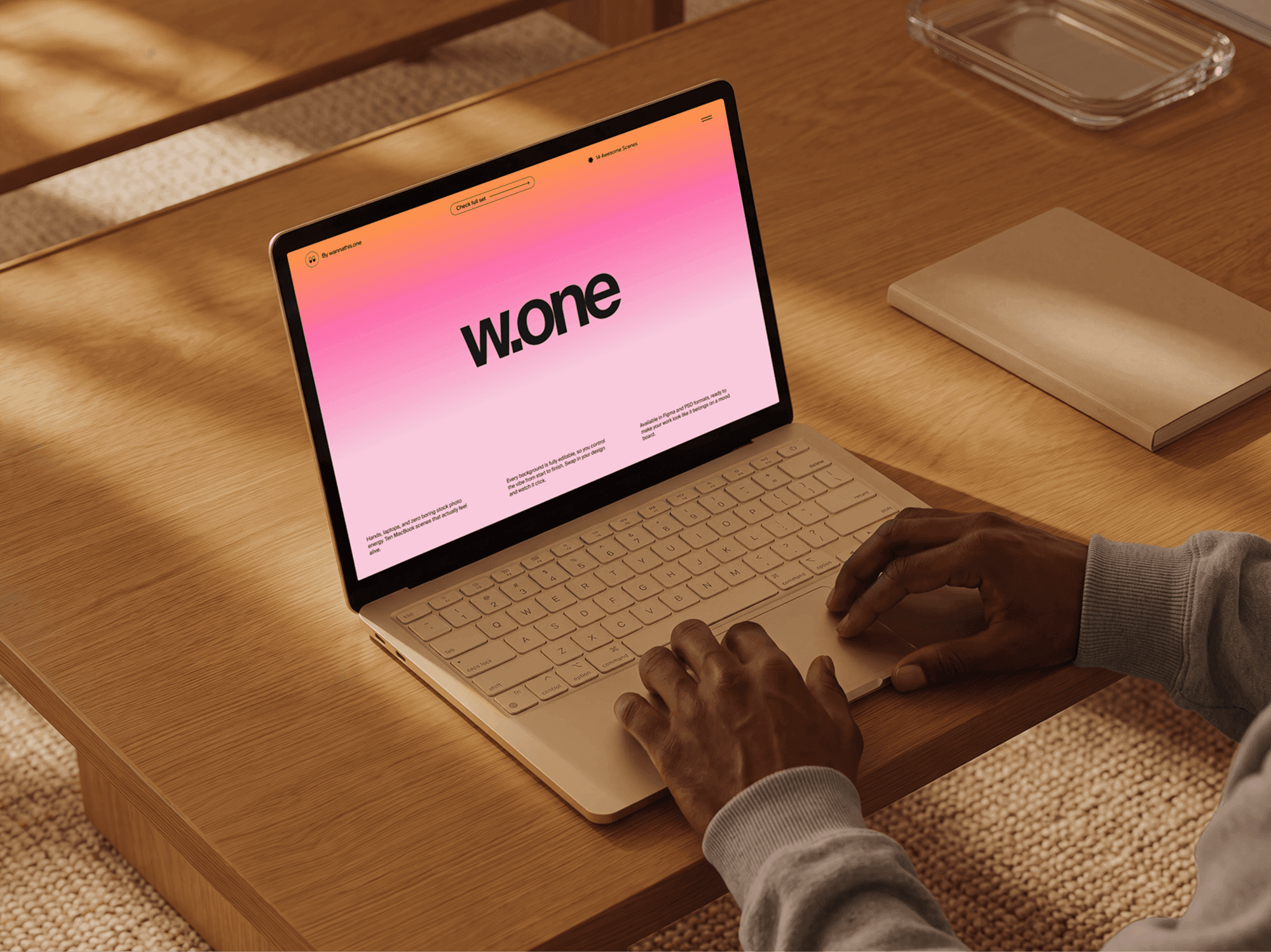 MacBook mockup on a refined wooden coffee table with hands on the keyboard in soft daylight interior