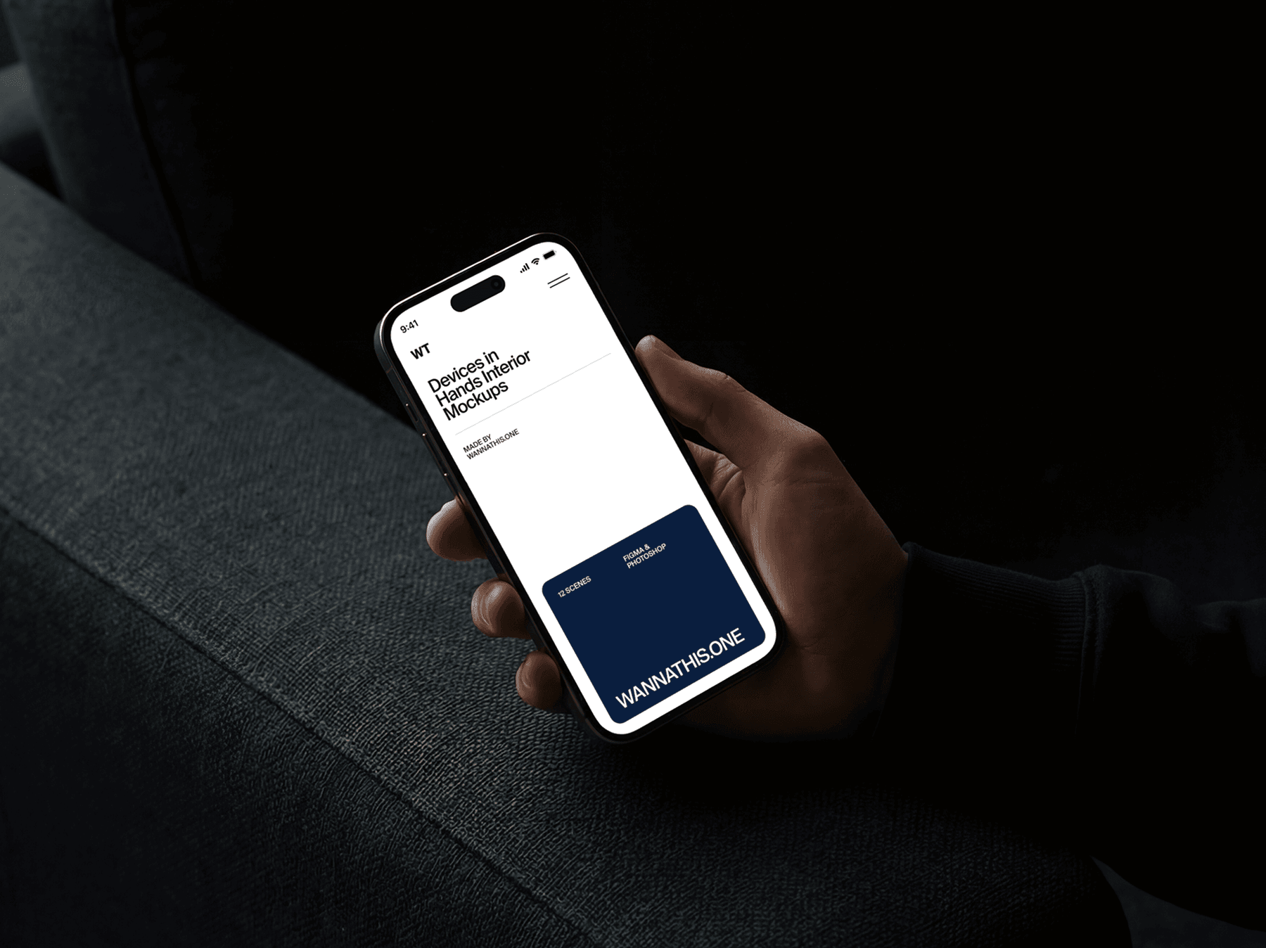 One hand holding an iPhone while seated on a sofa indoors