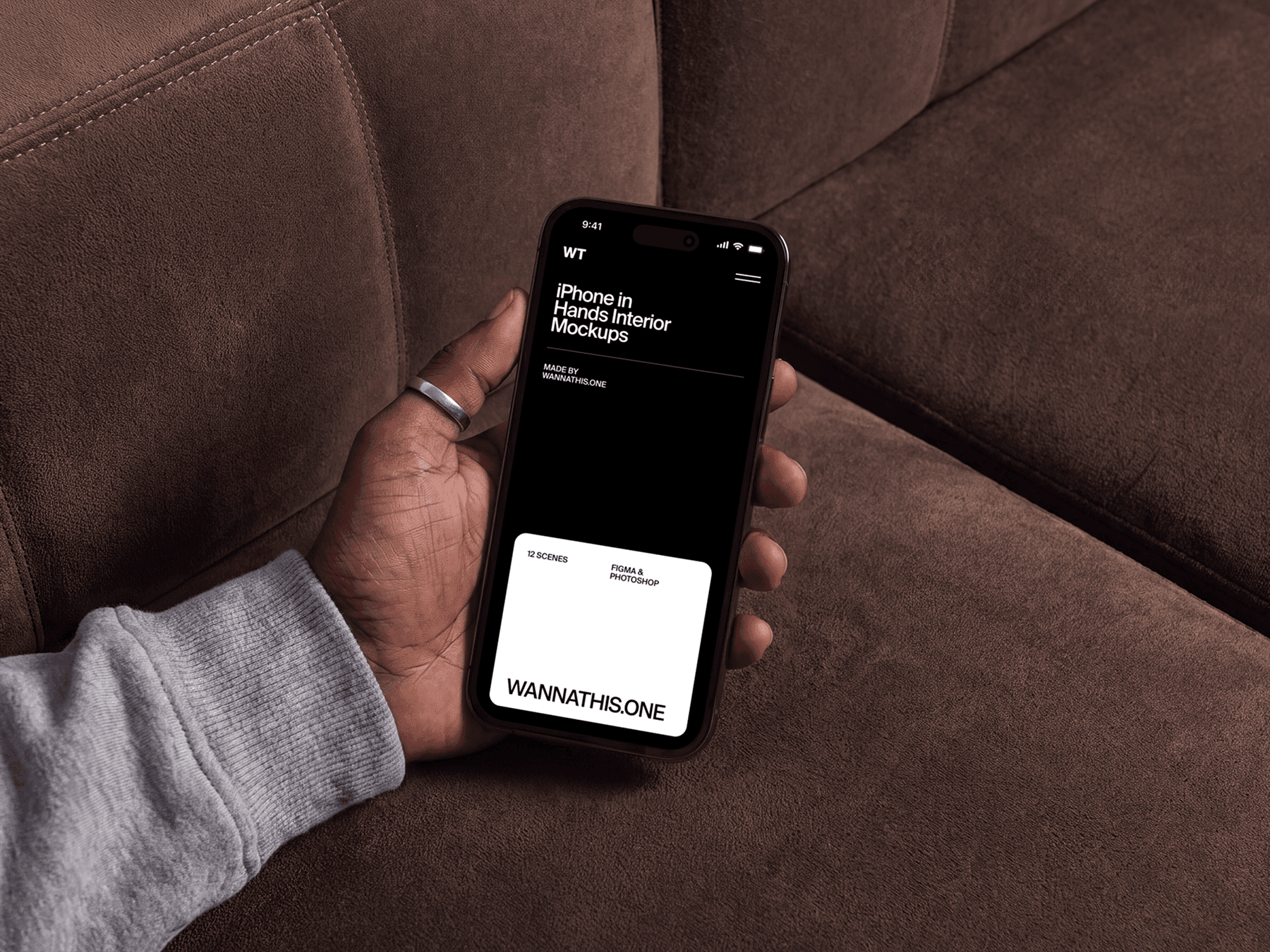 Close up of a hand holding an iPhone mockup in a warm lounge environment with soft daylight