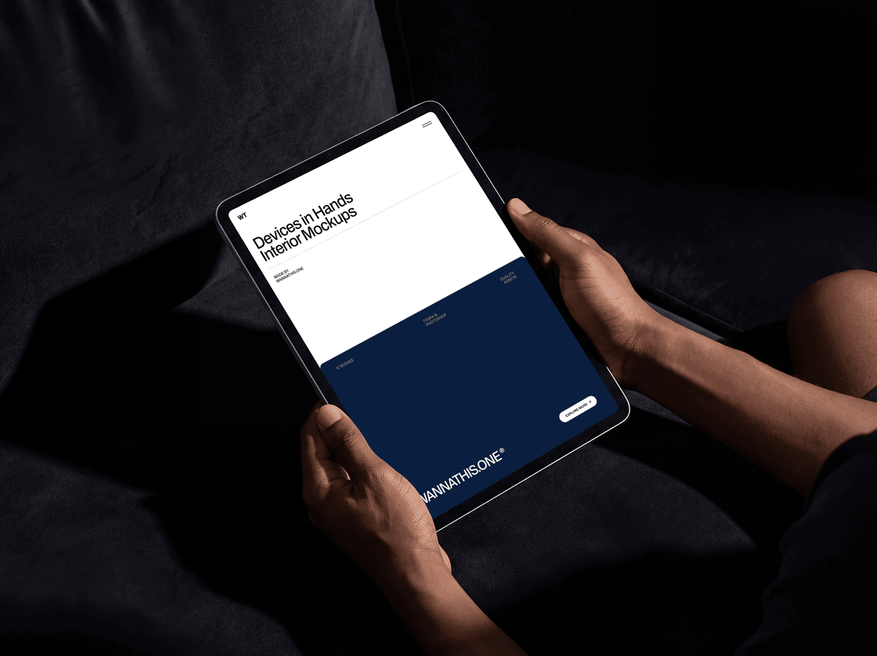 Person holding a tablet with both hands while seated indoors