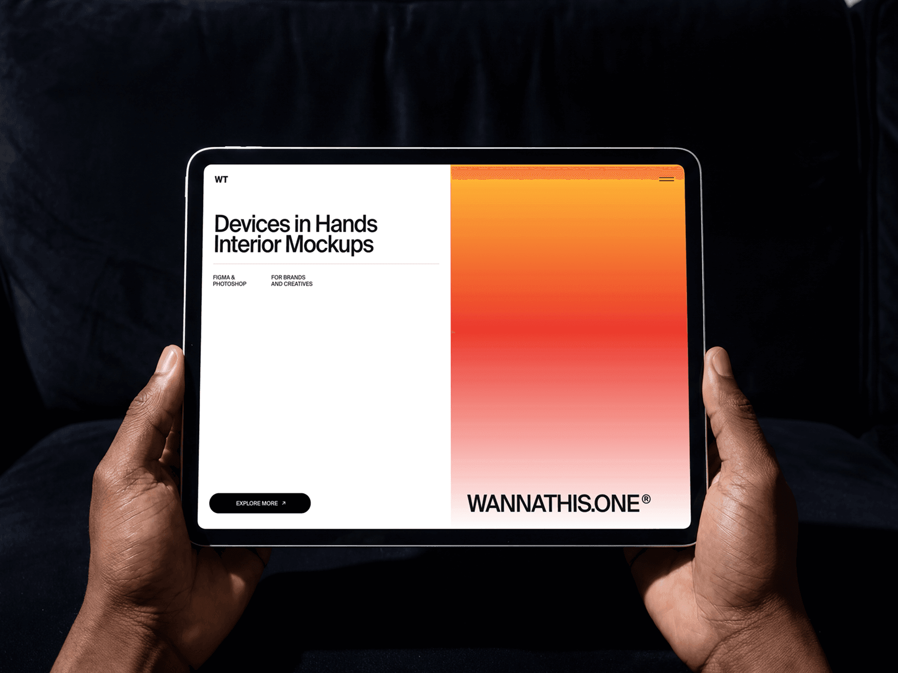 Person holding a tablet with both hands while seated on a sofa