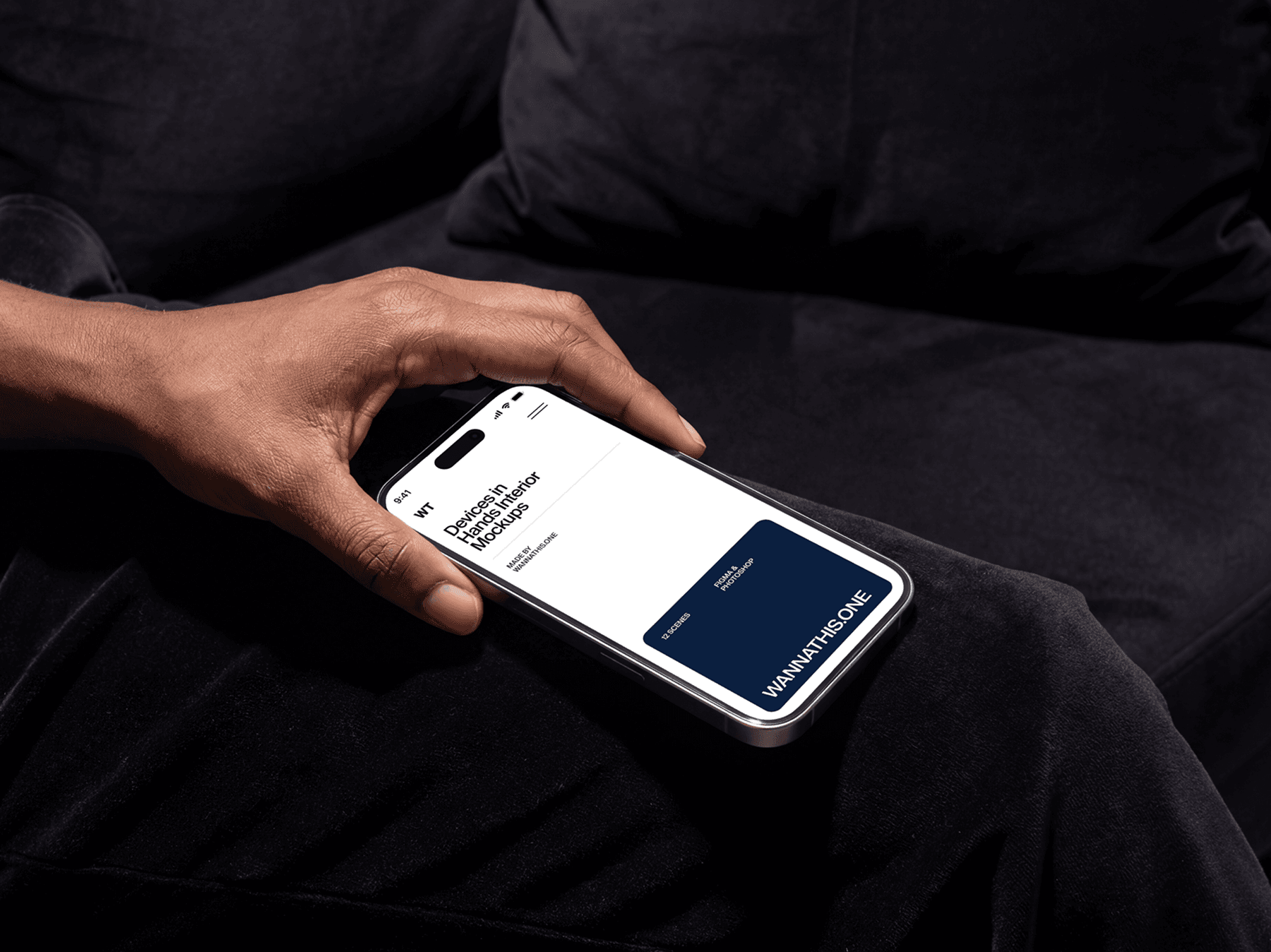 Hand holding an iPhone in horizontal position while seated indoors