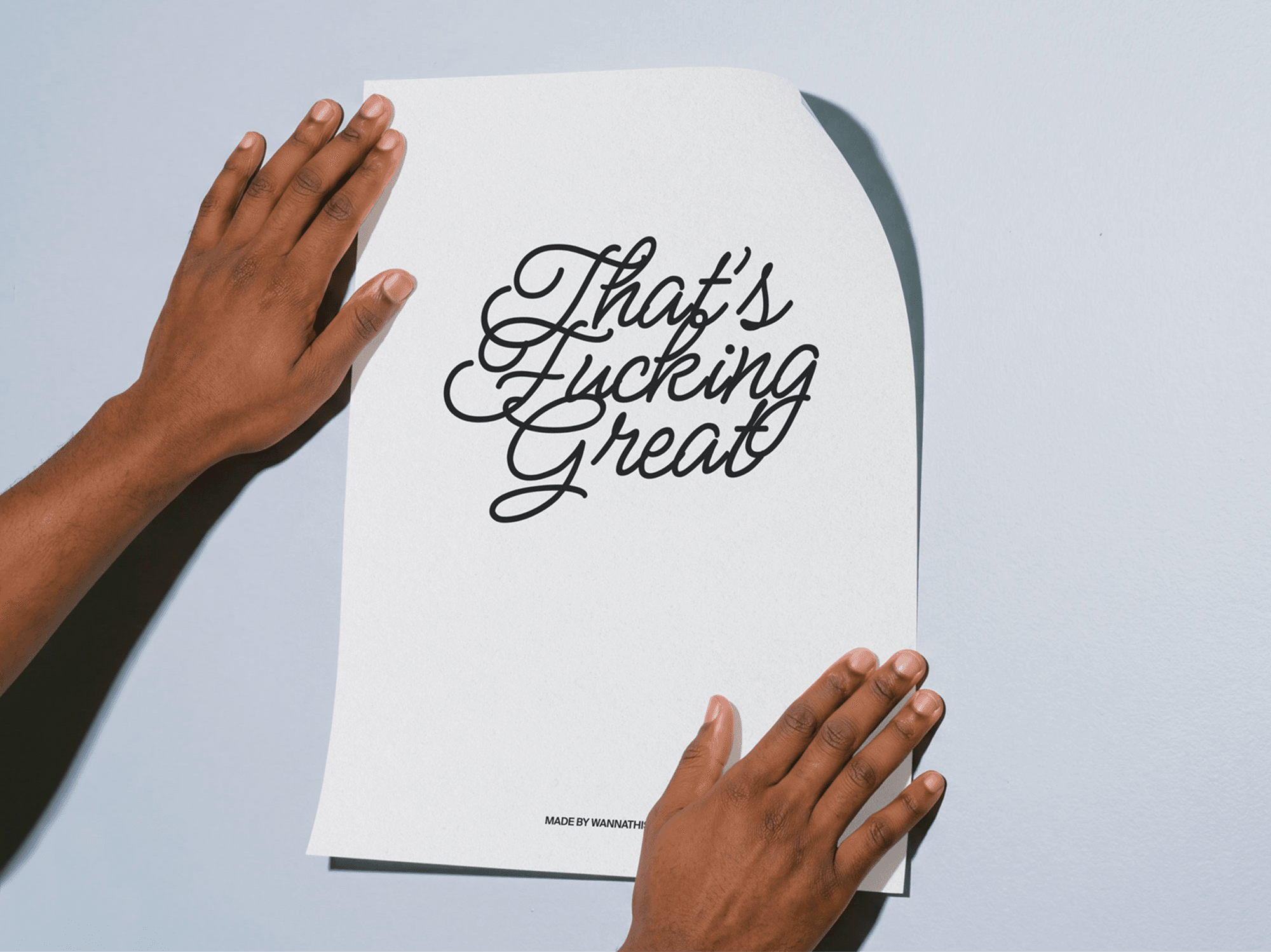 Hands holding a curved editorial poster mockup against a refined wall in a clean minimal studio scene