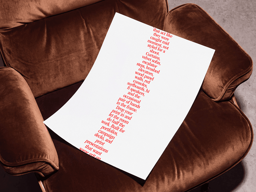 Editorial poster mockup placed on a refined velvet chair seat in a soft warm interior studio scene