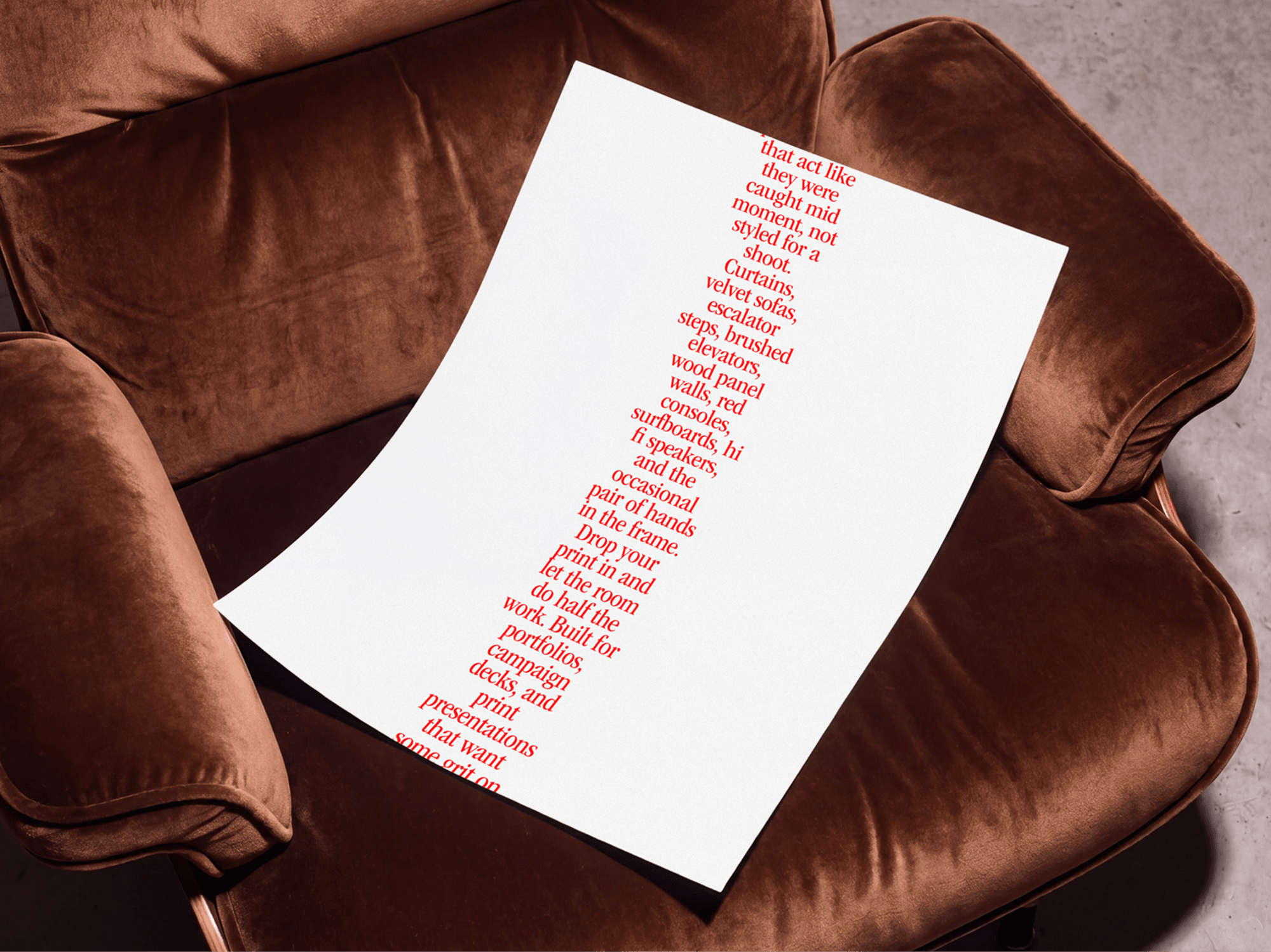 Editorial poster mockup placed on a refined velvet chair seat in a soft warm interior studio scene