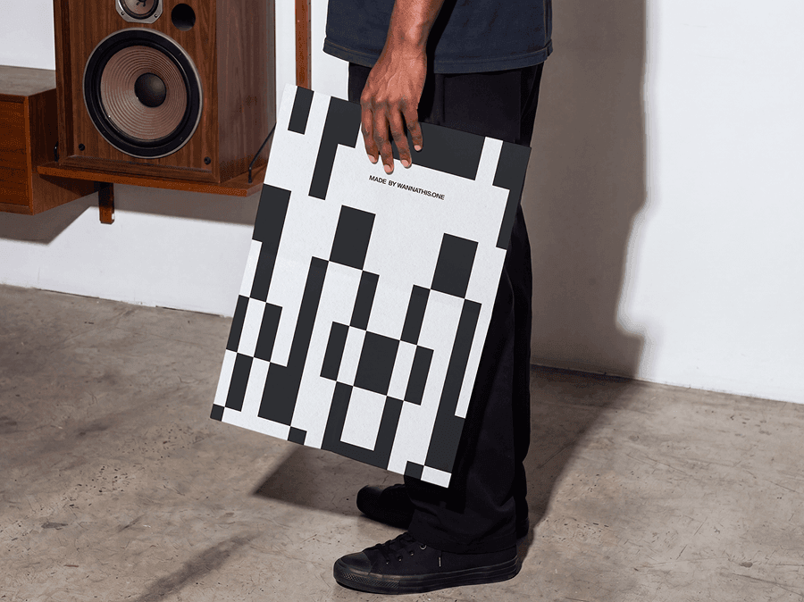 Person holding a large editorial poster mockup indoors in a refined minimal studio scene with natural light