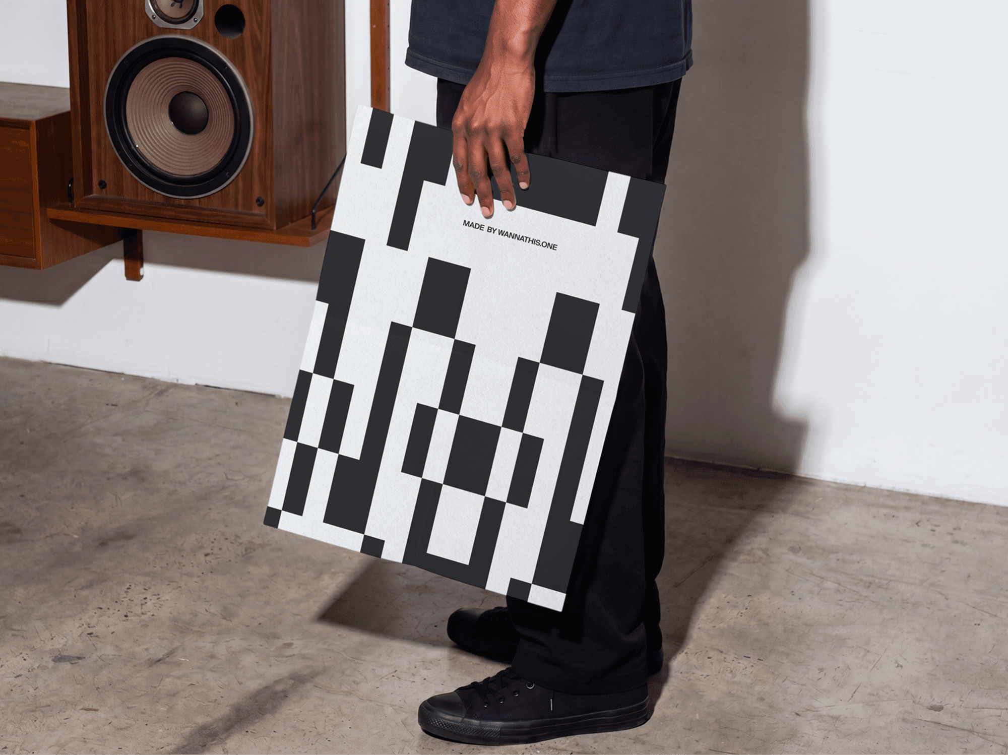Person holding a large editorial poster mockup indoors in a refined minimal studio scene with natural light