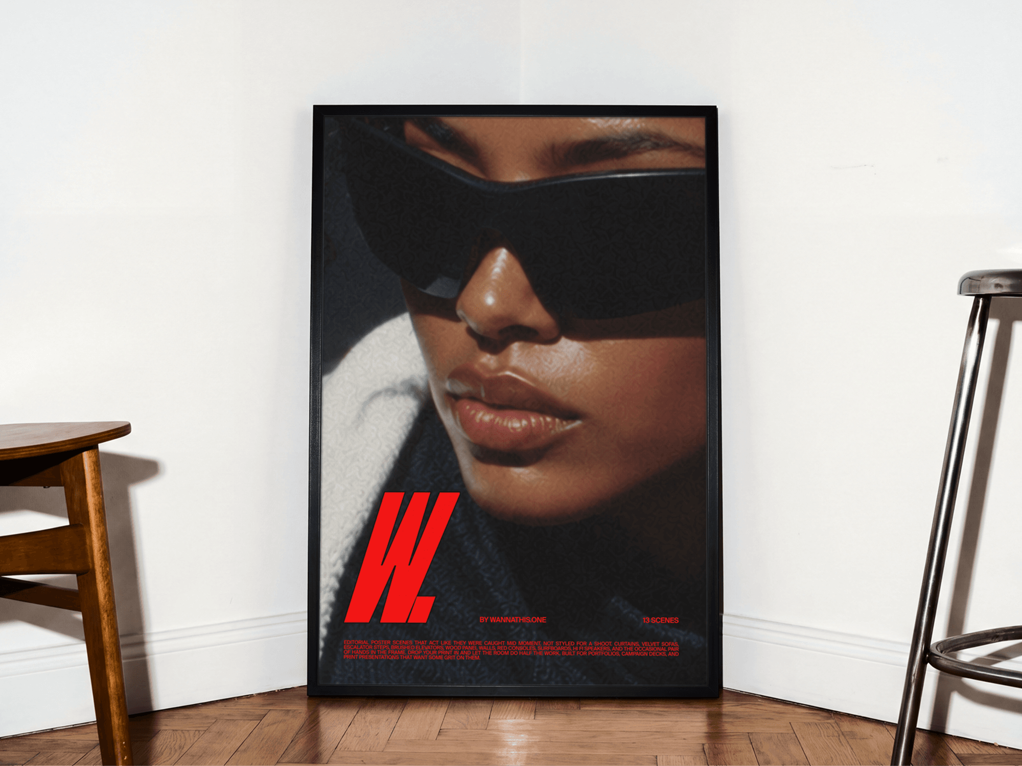 Large framed editorial poster mockup leaning against a refined wall on a warm wooden floor in modern interior scene