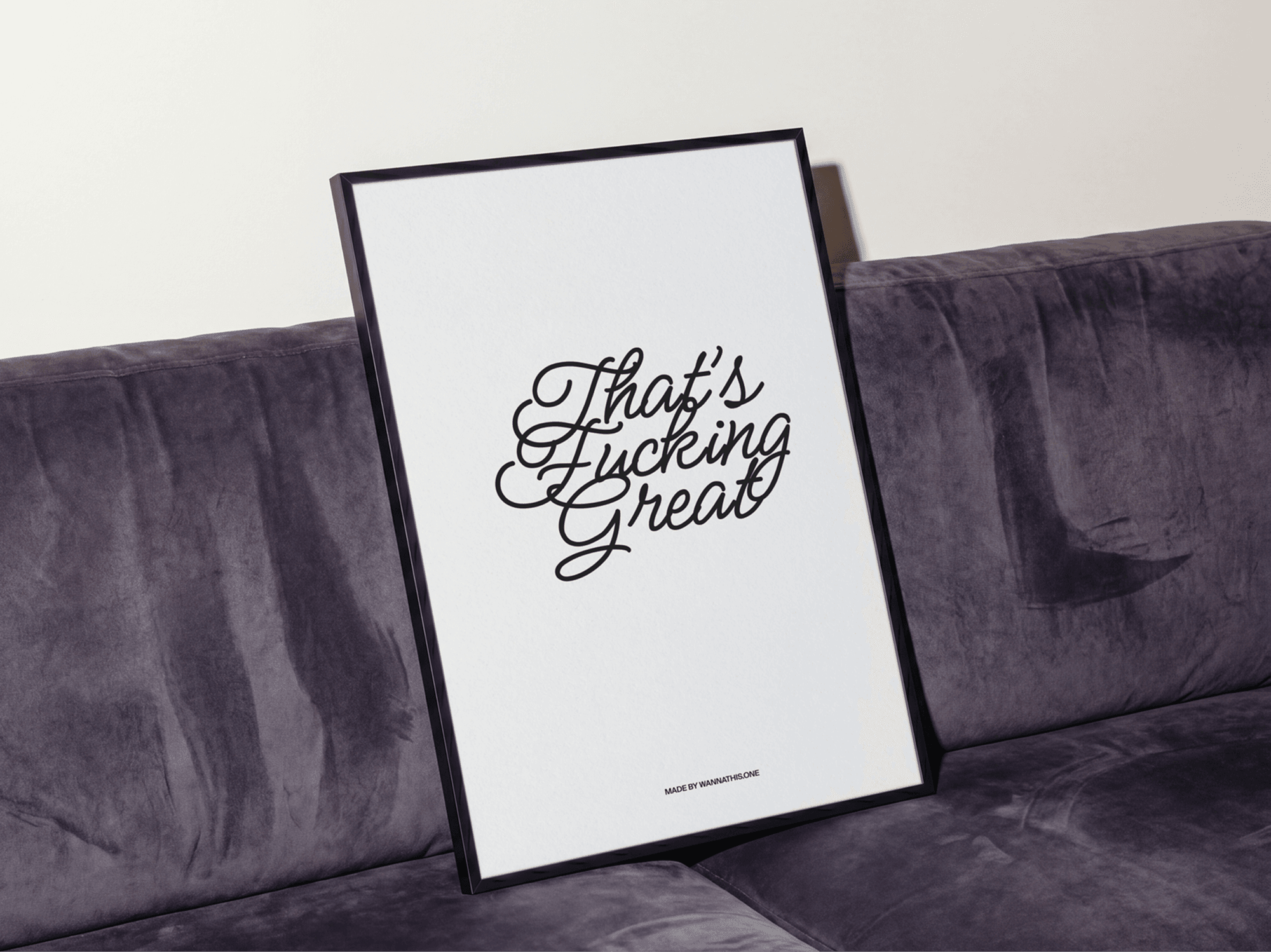 Framed typography poster mockup leaning on a soft refined sofa in a clean minimal interior studio scene