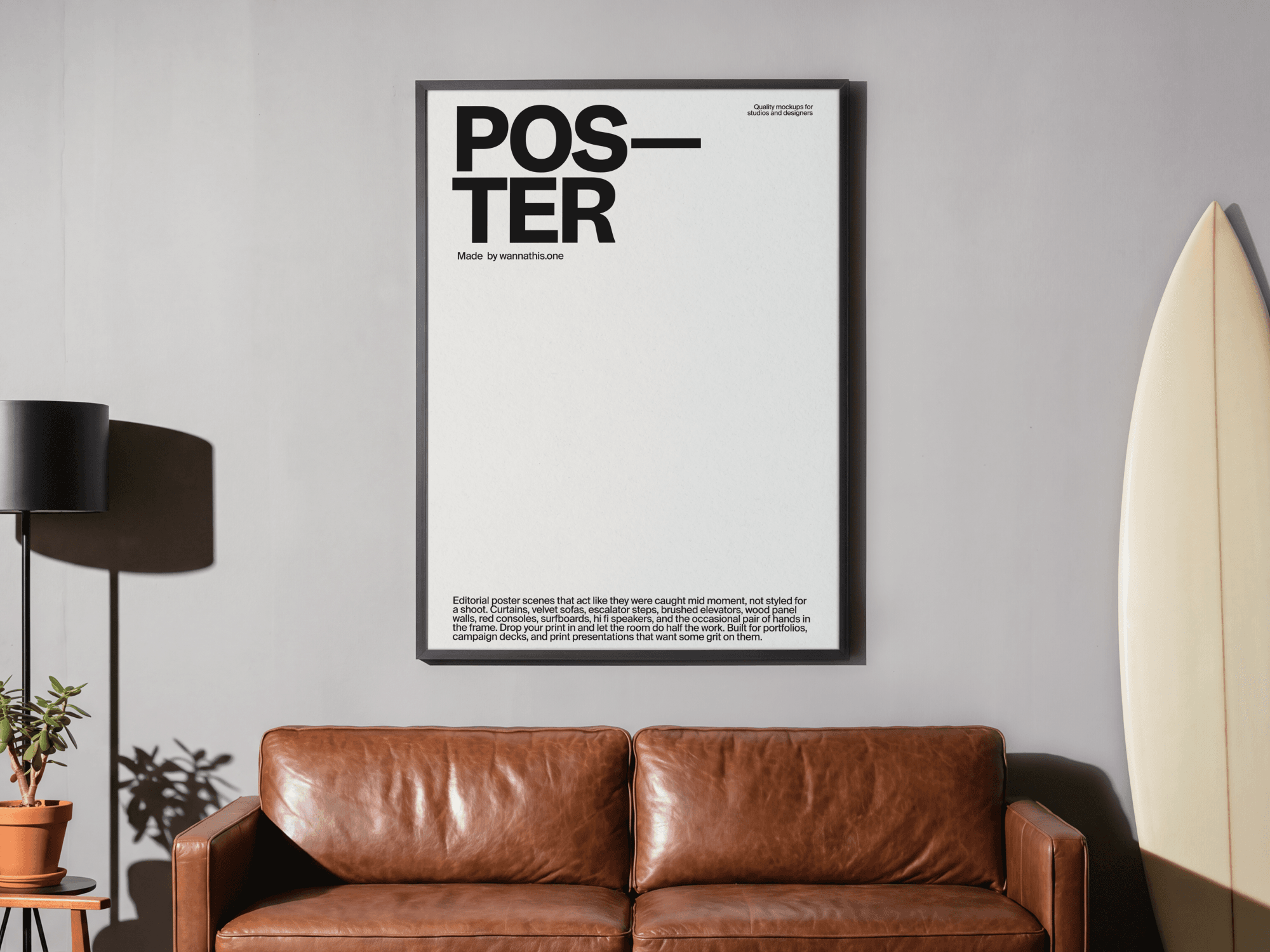 Large framed editorial poster mockup hanging above a leather sofa in a refined modern interior living scene