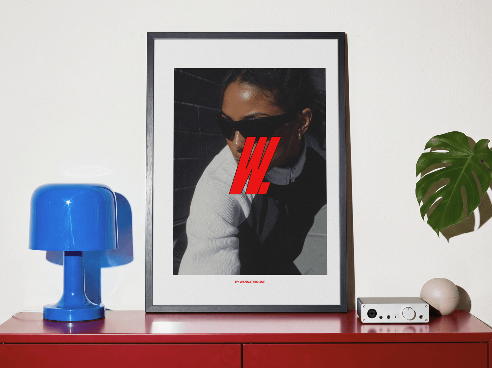 Framed editorial poster mockup displayed in a refined modern interior scene with directional natural light