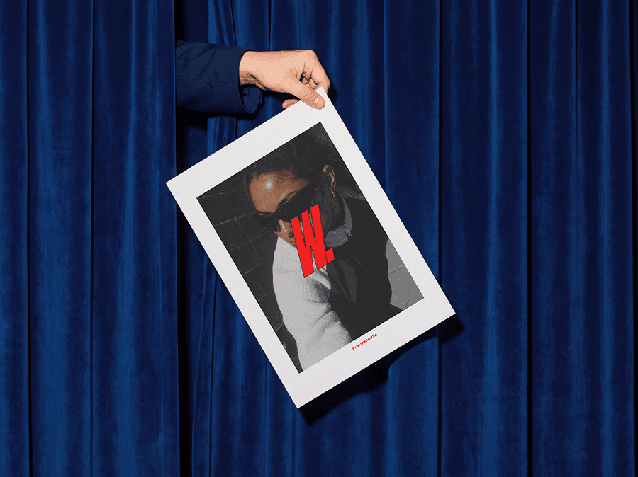 Person holding an editorial poster mockup in front of soft refined curtains in a clean indoor lifestyle scene