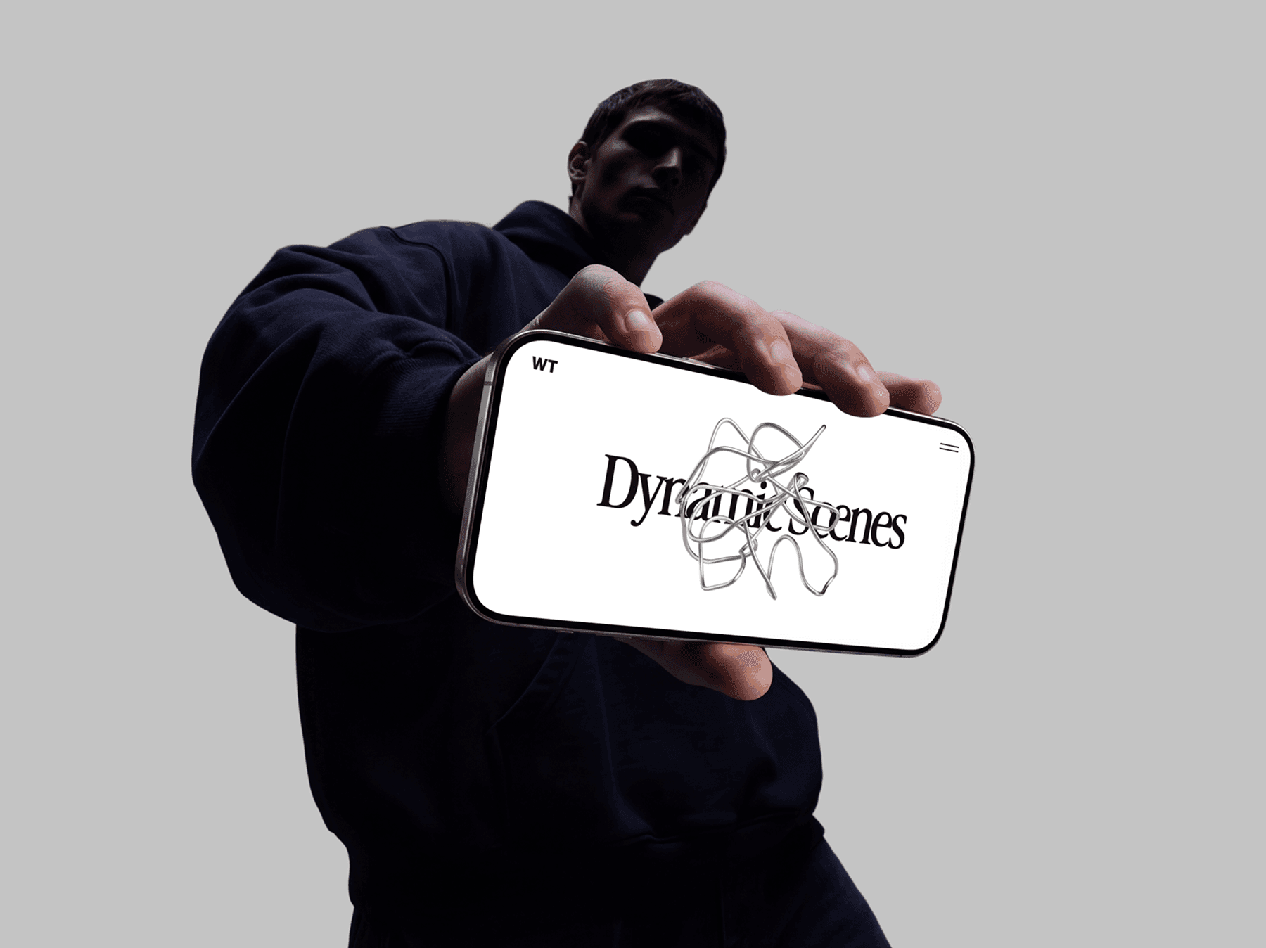 Hand holding an iPhone mockup in landscape orientation with fashion styling