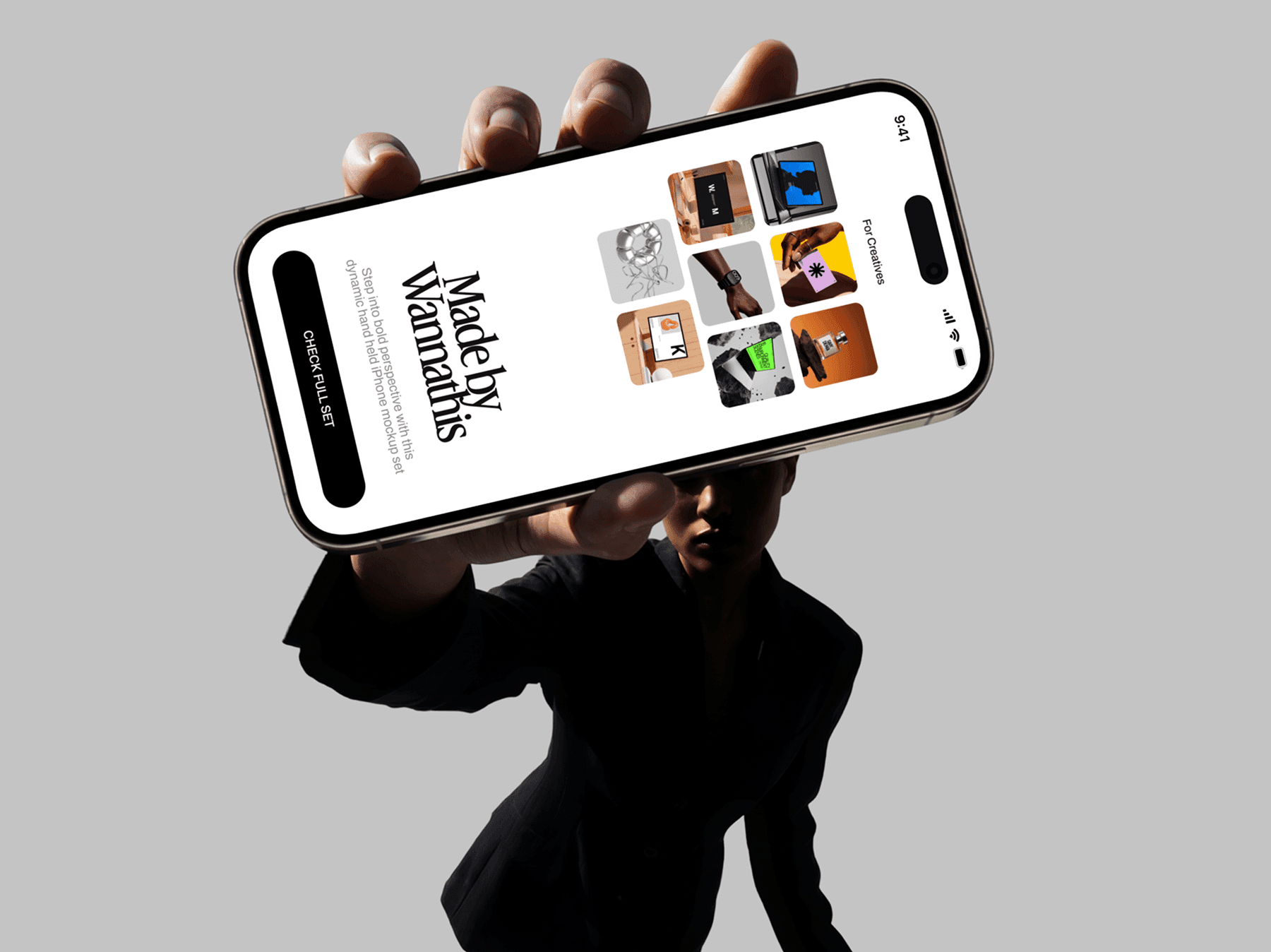 Person presenting an iPhone mockup toward the camera in an editorial pose