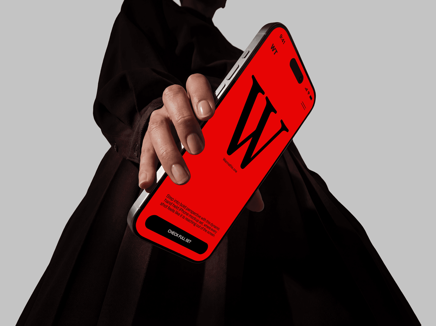 Person holding an iPhone mockup close to the camera in a dramatic fashion pose