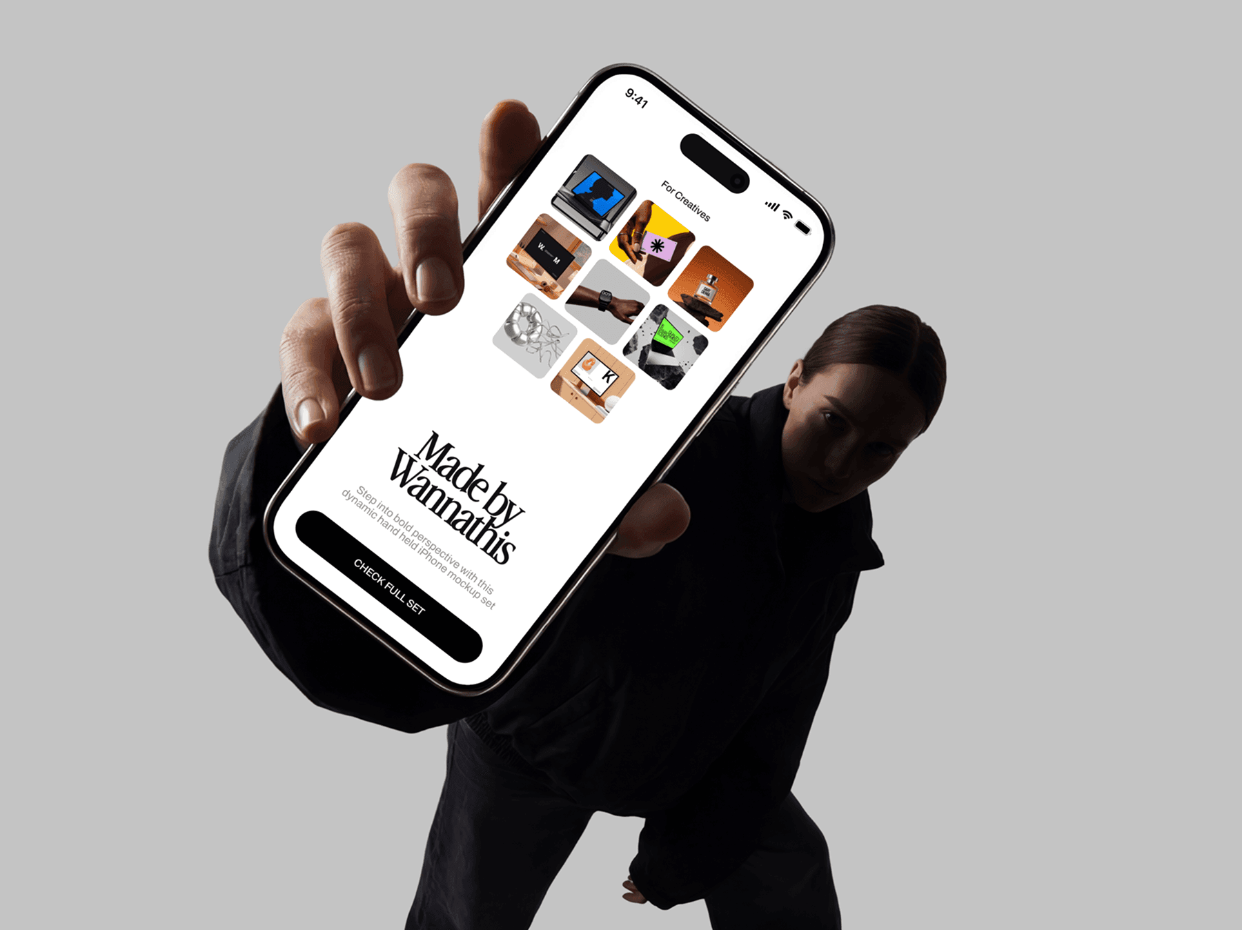 Fashion model presenting an iPhone mockup toward the viewer