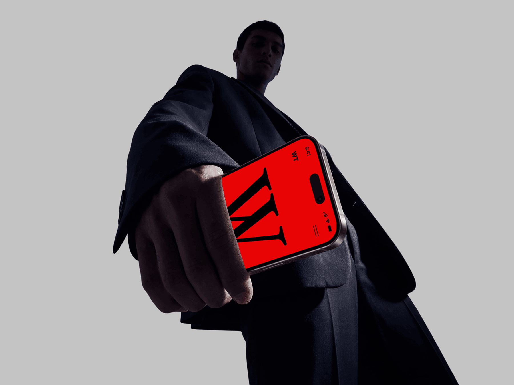Low angle view of a person holding an iPhone mockup toward the camera