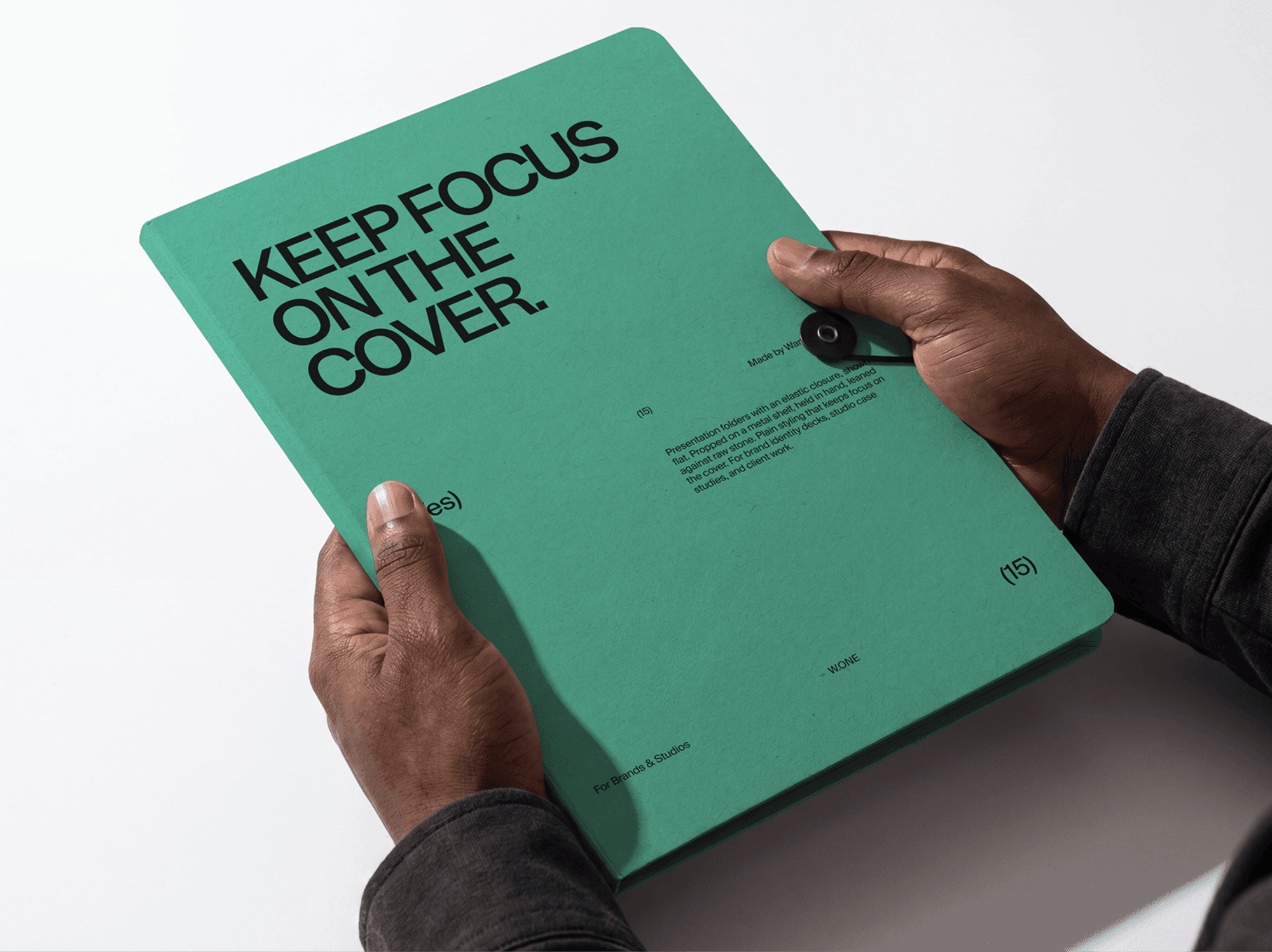 Presentation folder mockup held with both hands from a straight front view in a refined studio scene