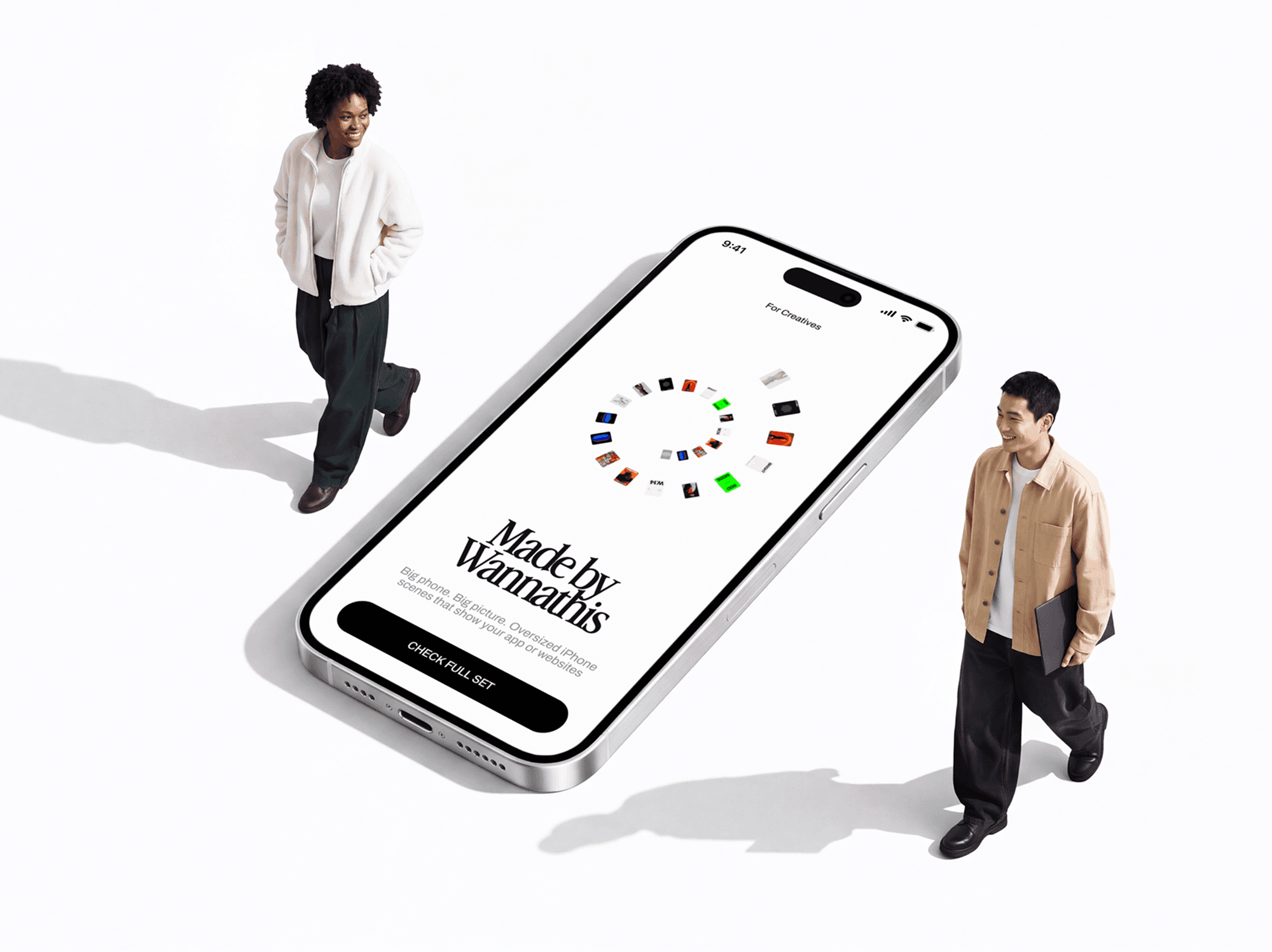 Oversized iPhone tilted on the ground with two people walking past beside it