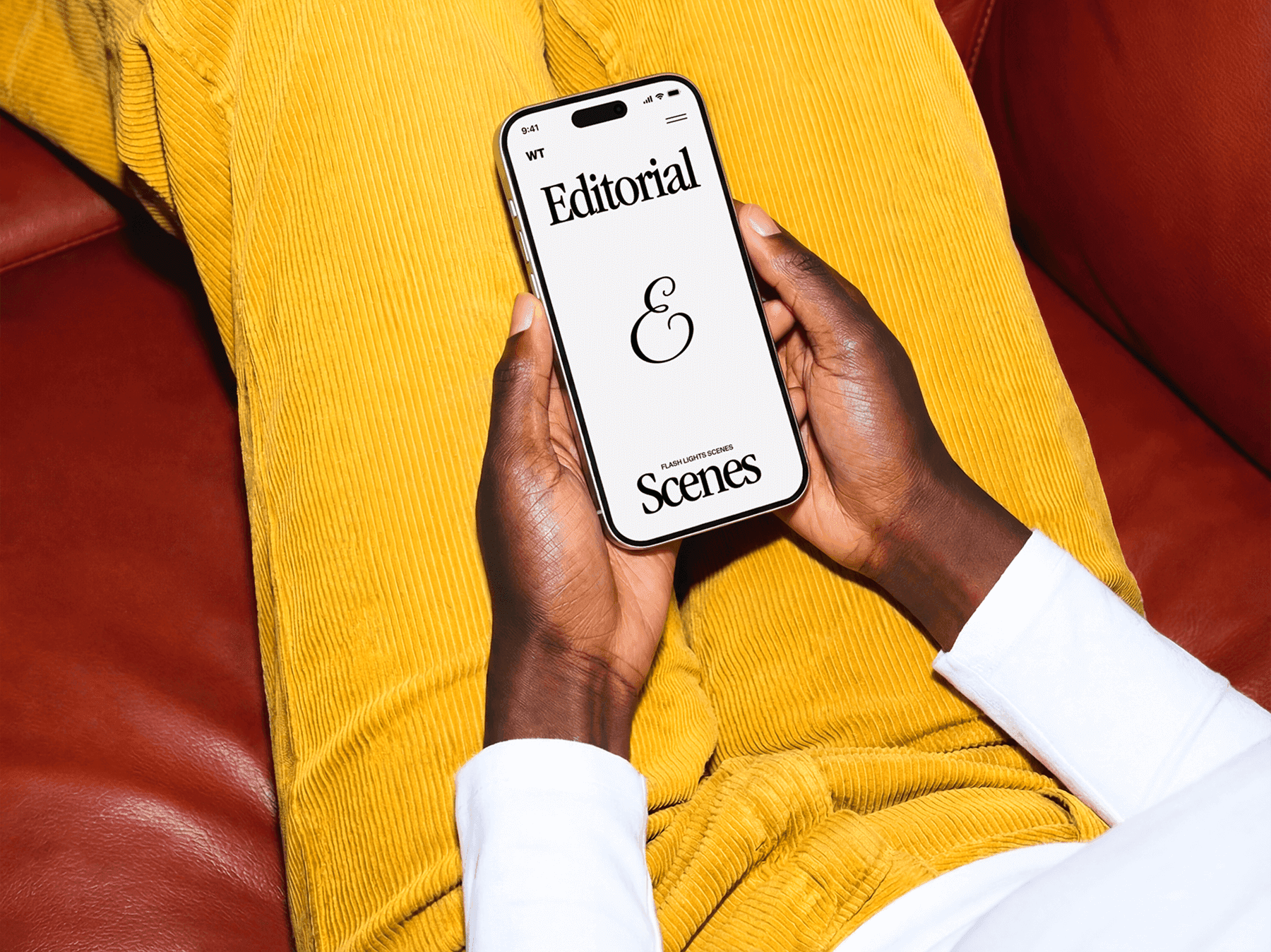 Close-up view of hands holding an iPhone while seated indoors