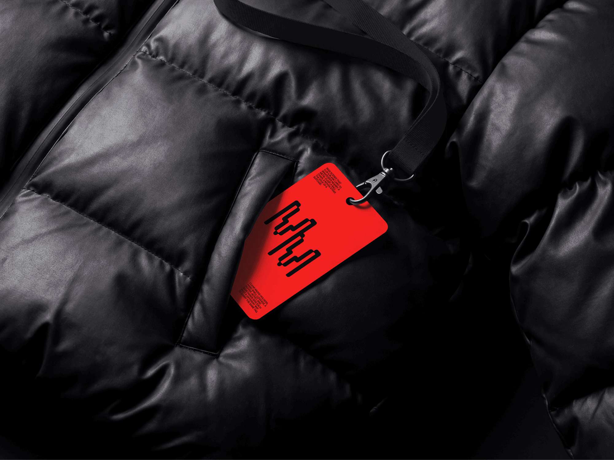 Pass card mockup attached to a lanyard and placed on a refined padded jacket surface in a lifestyle scene