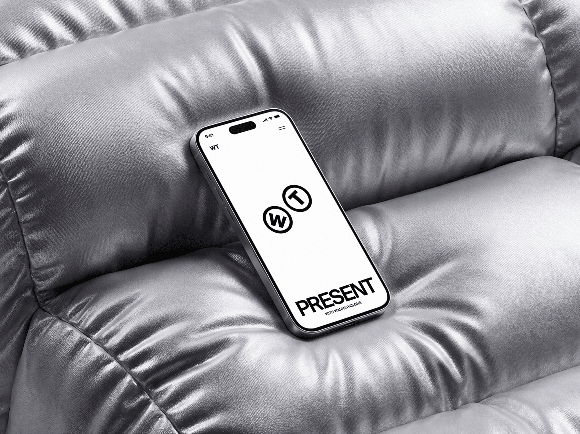 Rounded inflatable sofa with an iPhone mockup resting on the seat between the arms