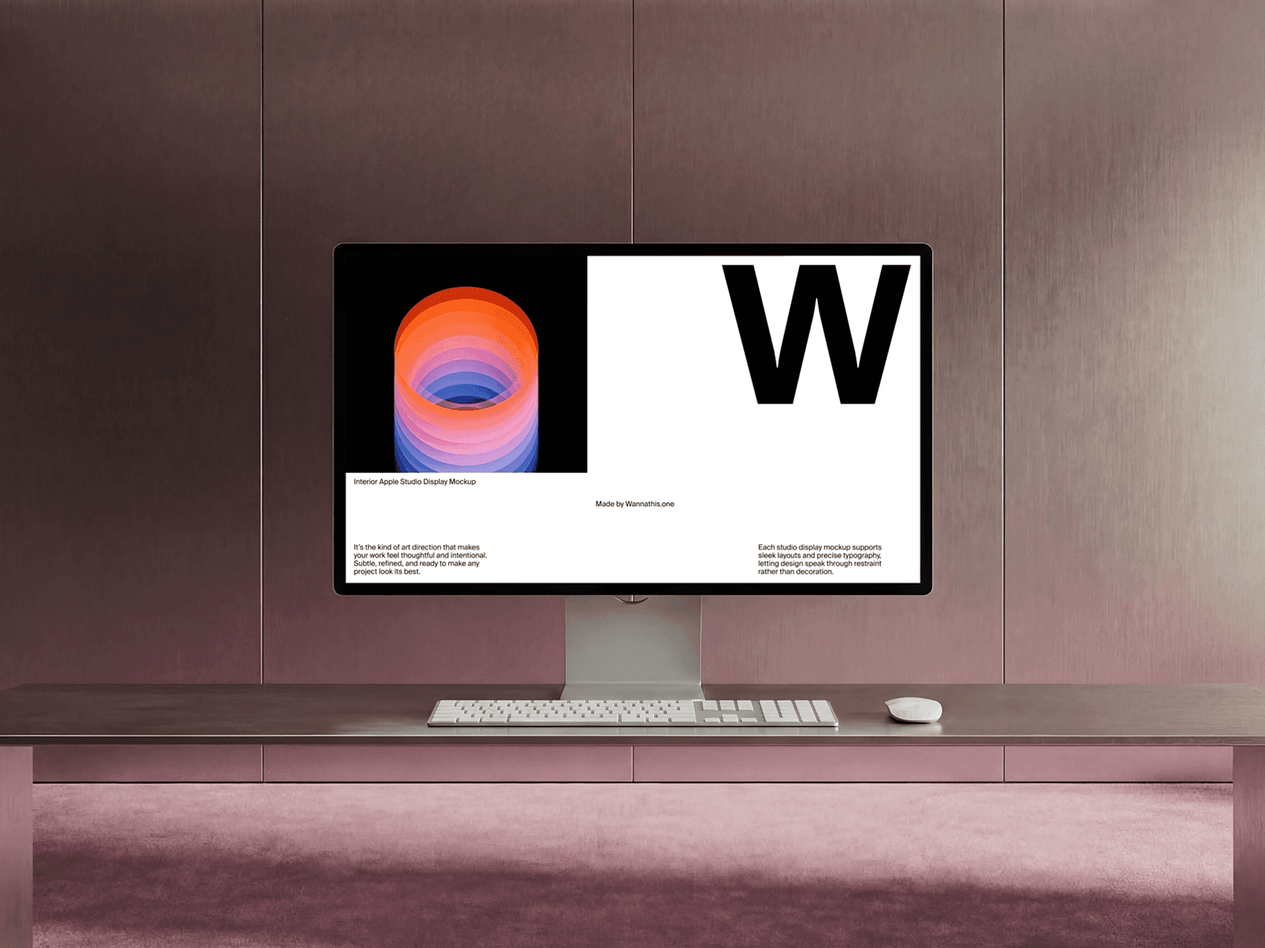 Studio display monitor on a long desk with keyboard and mouse