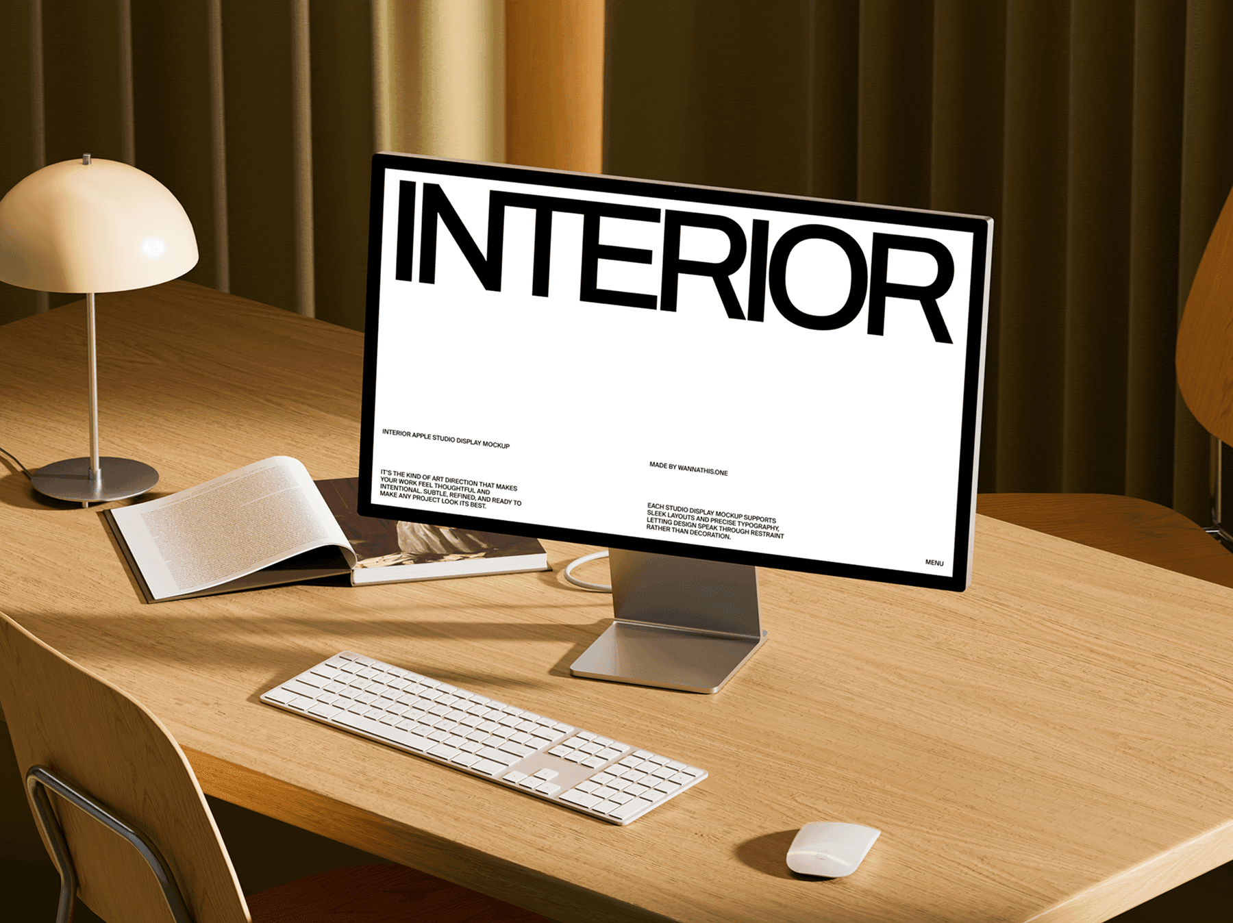 Studio display monitor on a wooden desk with keyboard and lamp