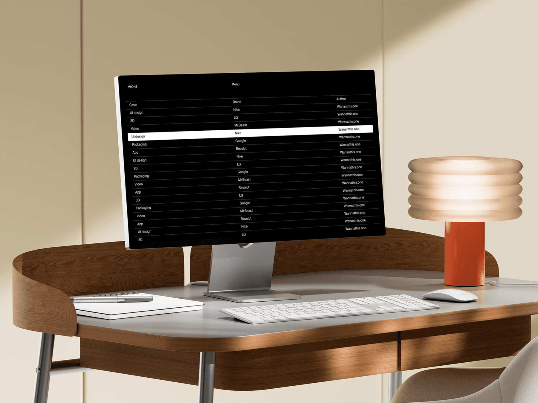 Studio display monitor positioned on a curved wooden desk in a modern room