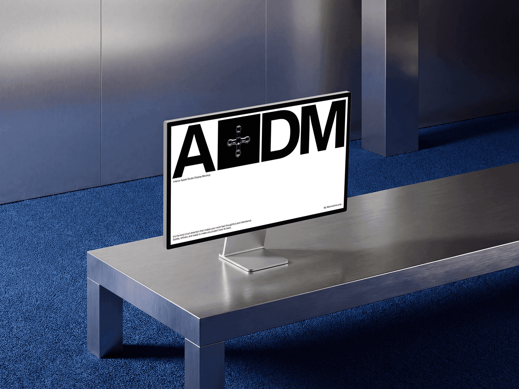 Wide studio display monitor positioned on a metal table in a modern space