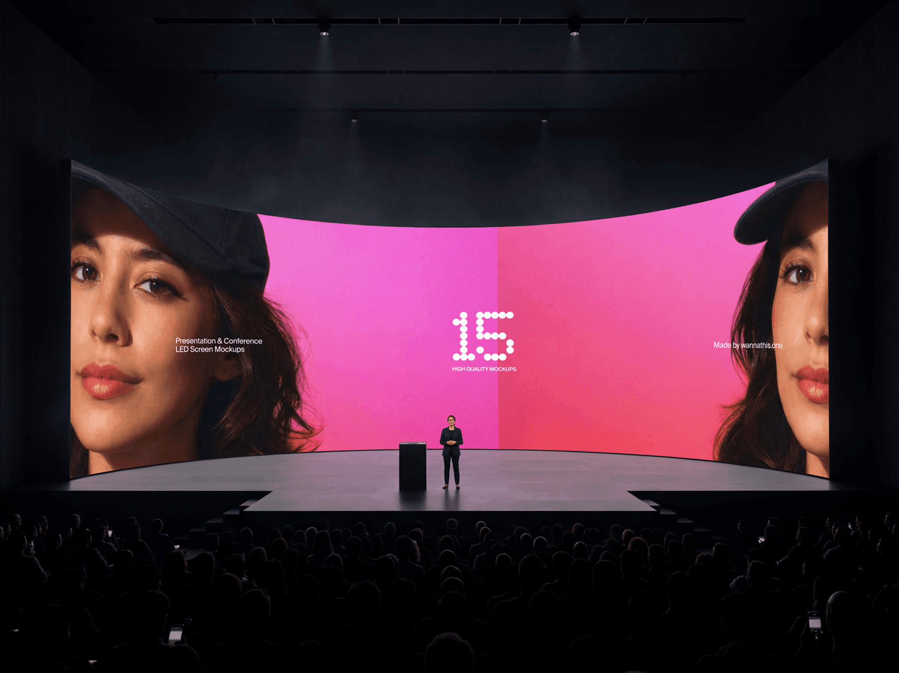 Wide curved LED screen on a large conference stage with audience seating