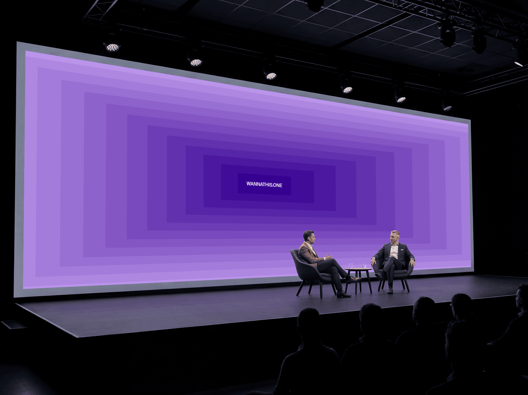 Large curved LED screen on a stage with two speakers during a conference talk