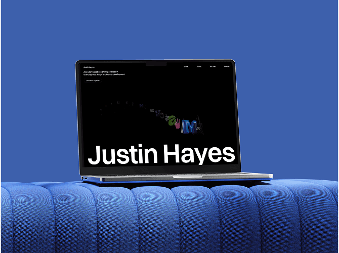 Justin Framer portfolio template on a MacBook resting on a blue sofa, dark hero with an oversized name headline, a clean template for freelance web designers