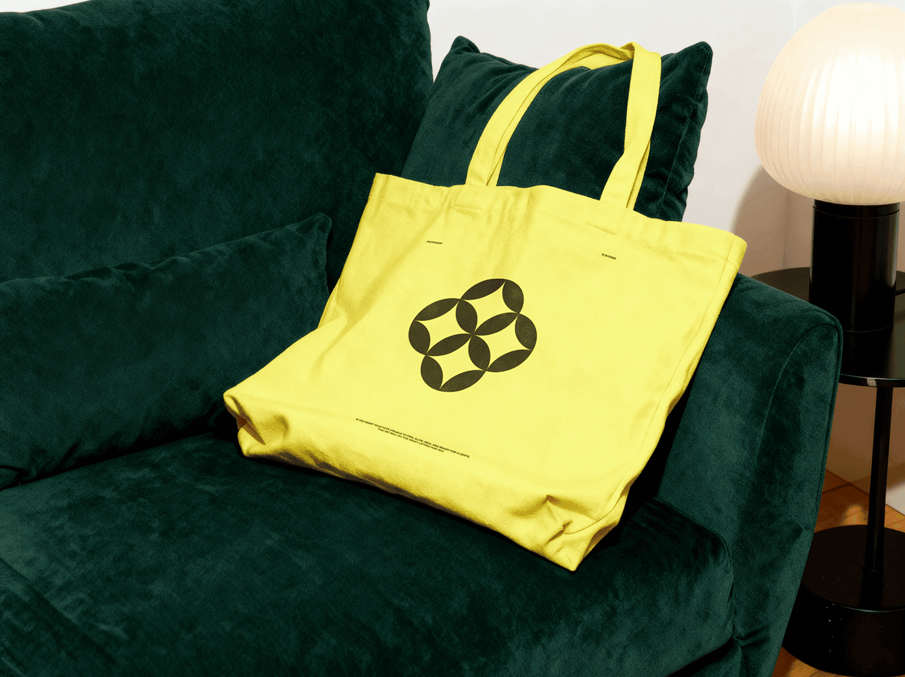 Tote bag mockup placed casually on a sofa in an interior setting
