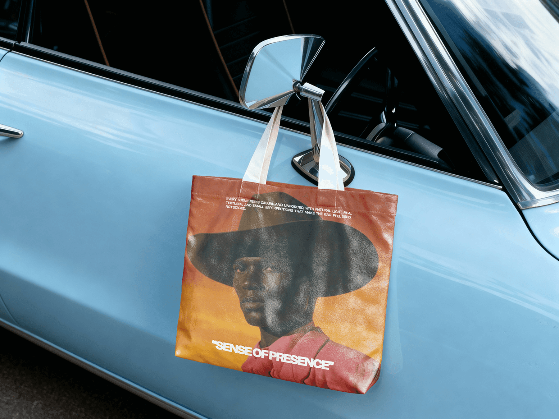 Tote bag mockup hanging from a car door in an outdoor lifestyle scene